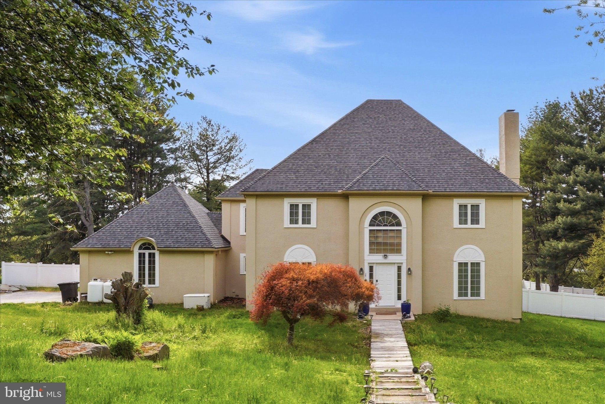 Welcome to this beautiful 4-bedroom, 2½-bath colonial situated on a premium one-acre lot on a quiet cul-de-sac. Just one block from 455+ acres of Natural Lands Trust trails and only 3 miles to town, this home offers the perfect blend of peaceful country living and convenient access. Nearby horse boarding and some of the area’s best riding trails make it ideal for equestrians.
Enter through the impressive foyer featuring a dramatic 20-ft ceiling and beautiful hardwood floors. To the left is a spacious dining room with elegant crown and chair rail molding. Across the foyer, the living room offers a warm brick fireplace and generous space for entertaining. The heart of the home is the roomy eat-in kitchen with cherry cabinetry, a built-in stove and microwave, and a large center island with cooktop. Sliding doors open to an enormous custom deck overlooking the private backyard. Upstairs, the luxurious master suite includes a walk-in closet and a bright bathroom with a jetted tub, separate stall shower, and dual sinks. Three additional spacious bedrooms and another full bath complete the second floor. The finished lower level provides a bonus room perfect for an office or additional living space, plus a large recreation room with a pool table. This well-maintained home features many recent updates, including a brand-new septic system installed in 2022 and a new roof installed in 2024. Additional upgrades include replacement windows, a new heater and air conditioner (2015), a new water heater, and a Generac whole-house generator for peace of mind. You’ll also appreciate the main-floor laundry, beautiful hardwood floors throughout much of the home, and the builder-finished basement. Located just minutes from West Chester Borough’s vibrant restaurants, shopping, and cultural offerings, and with easy access to major routes, this home truly has it all.