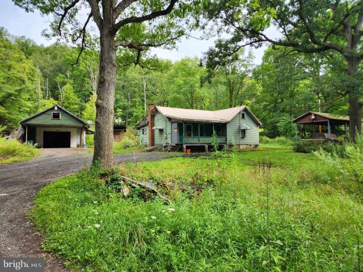 A beautiful, and secluded .59 Acre lot just minutes from town! Keep the structure and repair it or tear down and start fresh! Public water, private sewer and electric all on site. Public sewer is available. Come explore the possibilities!