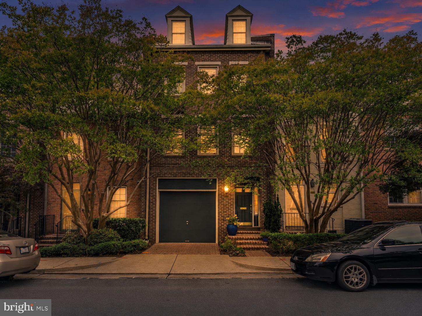 Rarely available four-level garage townhome in the coveted Canal Way community of North Old Town Alexandria. Nestled within one of Alexandria’s most charming and private enclaves, Canal Way is known for its classic brick colonial architecture, tree-lined courtyards, pedestrian walkways, and peaceful residential atmosphere just moments from the vibrant waterfront and historic heart of Old Town.

Ideally located in sought-after ZIP code 22314, residents enjoy exceptional walkability to the Potomac River, Mount Vernon Trail, coffee shops, restaurants, grocery stores, fitness studios, and the evolving North Old Town waterfront district. Commuters will appreciate the close proximity to Braddock Road Metro, Reagan National Airport, the GW Parkway, and Washington, DC.

This beautifully updated residence combines timeless elegance with extensive modern upgrades and sophisticated indoor and outdoor living spaces designed for both everyday comfort and effortless entertaining.

The lower level features an inviting recreation room complete with a fireplace, wet bar, built-in bookcases, and a full bath with a newly installed glass shower door. Two sets of double doors open directly to the stunning private all-brick patio, creating seamless indoor-outdoor flow and the perfect setting for entertaining, outdoor dining, or relaxing in a quiet courtyard atmosphere.

The main living level offers generous entertaining spaces filled with natural light. The updated kitchen features a SubZero refrigerator, Fisher & Paykel two-drawer dishwasher, new microwave, and a spacious casual dining area. Adjacent to the kitchen are the expansive formal dining room and elegant living room featuring a fireplace and two Juliet balconies overlooking the beautifully landscaped private patio below.

The luxurious primary suite serves as a true private retreat. The spacious bedroom features its own fireplace, a large walk-through closet connecting directly to the bath, and an additional oversized closet for exceptional storage. The completely renovated 2026 primary bathroom delivers a spa-like experience rarely found in Old Town. Exceptional designer finishes include quartz vanity countertops, porcelain floor and wall tile, floating vanities with smart under-cabinet adjustable LED lighting, concrete vessel sinks, front and back LED-lit mirrors, front-lit medicine cabinets with built-in receptacles, and a smart toilet with integrated bidet functionality including temperature-controlled water, heated seat, automatic open/close seat cover, and air dryer with adjustable temperature and wind controls. Additional luxury elements include a towel warmer, 10X LED magnifying mirror with adjustable light color, recessed color-adjustable LED lighting, European LED pendant lighting, adjustable gimbal LED lighting, smart switches, and Schluter heated flooring throughout both the bathroom and shower area.

The expansive shower showcases a frameless EnduroShield-treated glass enclosure with Low-E glass, double rain shower heads with Delta controls, Schluter shower system with linear drain, and an illuminated recessed niche, creating a true luxury spa environment within the home.

The fourth level offers an ideal private guest suite complete with its own full bathroom and multiple closets, providing comfort and privacy for visitors, extended family, or an additional home office retreat.

Additional notable upgrades throughout the home include Pella windows installed throughout in 2021, roof and attic vent replacement, updated exterior painting including dormer windows, redesigned fireplace mantels, recessed lighting additions, security and camera systems, new front door with brass hardware, updated landscaping, and a beautifully renovated garage featuring an epoxy floor finish, new garage door, and updated remote controls.

Rarely does a home become available in Canal Way offering this combination of refined luxury, extensive renovations, private outdoor entertaining space, garage