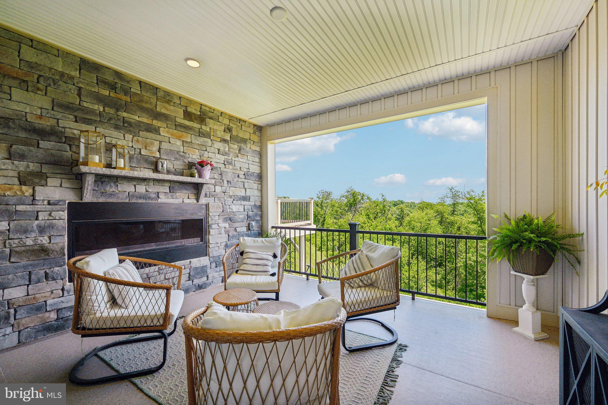 Welcome to 13719 Hunt Valley Court, a simply gorgeous luxury garage townhome in the highly sought-after Longview Ridge community. Perfectly positioned on a premium lot with breathtaking views and maximum privacy, this stunning 2023-built home offers over $50,000 in upgrades and combines elegant design with modern convenience.

From the moment you enter, you'll be impressed by the abundance of natural light, soaring ceilings, LED recessed lighting, and an open-concept floor plan designed for today's lifestyle. The heart of the home is the spectacular chef's kitchen, featuring a massive center island, custom tile backsplash, stainless steel appliances, designer range hood, and exceptional finishes throughout. The adjoining living and dining areas flow seamlessly to a truly unique enclosed terrace complete with a striking stone accent wall and built-in gas fireplace, creating the perfect space for year-round entertaining and relaxation.

Upstairs, the luxurious owner's suite features a tray ceiling, spacious walk-in closet, and a spa-inspired en-suite bath with a double vanity, custom tiled shower, and private water closet. Three additional bedrooms, two full baths, and two half baths provide plenty of room for family and guests.

The finished lower level offers incredible versatility with a spacious family room featuring soaring ceilings, ideal for movie nights, a home office, fitness space, additional entertaining or a bedroom. A two-car garage and private driveway provide ample parking and convenience.

Located just minutes from Hunt Valley Towne Centre, enjoy easy access to Wegmans, upscale shopping, restaurants, fitness centers, entertainment, and some of the area's premier country clubs. With quick access to I-83, beautiful Greenspring Valley nearby, and top-rated schools, this exceptional home delivers luxury townhome living at its finest in one of Baltimore County's most desirable communities.