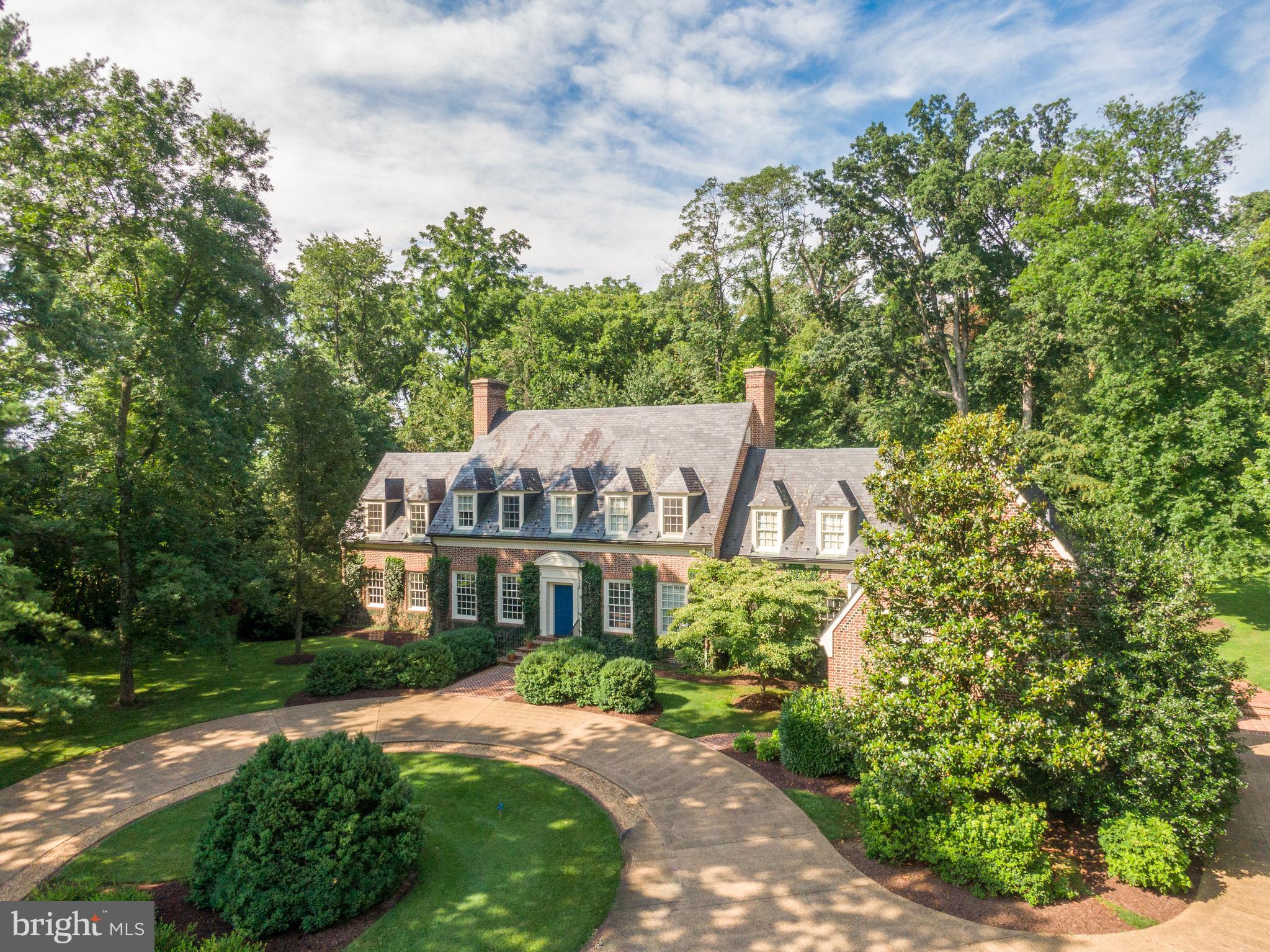 Welcome home to 261 Merrifield Lane! This private Georgian Revival estate boasts of idyllic solitude among mature trees and immaculate landscaping, with a short drive to the adjacent city of Winchester, Virginia. 

This exquisite, all brick, three-level home is custom made, with attention to the finest detail. The tree-lined drive up to the home is stunning and complete with a circular pebble driveway. The atmosphere you experience is peaceful, private, and luxurious.

As you enter the home, a grand foyer greets you with an extra-wide wooden, open staircase. 
The light-filled kitchen is a sight to behold… with terra cotta tile, custom-designed hardwood counter tops, double oven, paneled subzero refrigerator, electric cooktop & paneled hood range, center island, Bosch dishwasher, microwave, brass bar sink, pull-out cabinetry, and 11 ft ceilings. 

The sunroom, located off the kitchen, features two brick walls, along with terra cotta polished tile, wide molding, coffered ceiling, and walk-out to the breathtaking outdoor space and patio. 
You will be drawn to the formal living room, with all its warmth and appeal. It is spectacularly designed with both chair molding and crown molding. It has a regal fireplace and gorgeous hardwood flooring. Large windows are a highlight on each end of the room.

The colorful dining room features a sparkling crystal chandelier. There is also a wood-burning fireplace, library paneling, hardwood flooring, wainscoting, dental moldings, and a 10 ft ceiling. 

The library boasts gorgeous floor-to-ceiling wood paneling, built-in bookcase, and built-in cabinetry, all handcrafted by a local artisan, as well as a cozy, wood-burning fireplace. 

The third floor is where you’ll find the three beautiful and unique bedrooms. 
The primary bedroom suite is a dream space for a romantic oasis after a long day. It has custom-made hardwood flooring, intimate fireplace, four window seats to sit and enjoy a glass of wine, and walk-in closet. You’ll be delighted to find his and her individual bathrooms, with two more cedar-lined walk-in closets, large soaking tub, walk-in shower, and tile flooring. 

The second bedroom is bright and cheery, with hardwood floors, double closets, and window seat. It also has a private, attached full bath with tile flooring.

The third bedroom is tucked down a hallway for quiet solitude and relaxation. It also has wood flooring and multiple windows for lots of sunlight. 

The owners had the prescience to build the laundry room on the third floor, just outside the third bedroom. What a brilliant convenience! 

Going down the lower stairway to the basement brings you to a warm and inviting family room. You will enjoy many hours with your family… playing games, watching your favorite shows, and entertaining guests at the bar. This room has carpeted flooring, built-in bookshelves and cabinetry, and wood-burning fireplace. There is also the convenience of a full bath down the hall. 
In addition to the family room, there is a fabulous office space on the opposite side of the stairs. With this work-from-home option, you can stay home and enjoy the beautiful scenery and the quietude of the estate. 
This discriminate home also offers an alarm system, air humidifier, and intercom system throughout. Just a few more examples of the elaborate attention given to the finest details!
Above the three-car garage, there is a delightful apartment with private entrance, perfect for an au pair or overnight guests. It includes nice-sized living area, kitchenette, bedroom with a full bath, closet, and laundry room.
This home is in a superb location! Just minutes from Rock Harbor Golf Course, The Museum of the Shenandoah Valley, Winchester Medical Center, and Winchester’s Historic District, which boasts fine dining, boutique shopping, and renowned festivals. Perfect commuter location with easy access to I-81, Route 7, and Route 50.
Book your appointment to see this charming, rare, private oasis today!