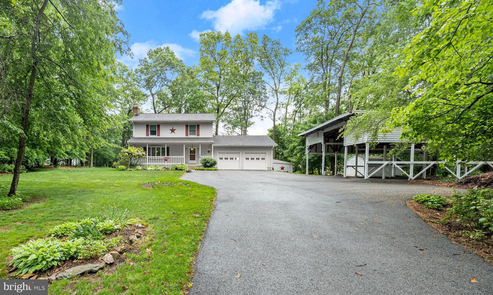 Lovely colonial on a private 2.9-acre setting. complete with an attached 2-car garage & a 3 bay detached carport big enough for your motor home, camper AND boat. This home has been meticulously cared for and updated over the years. Items like the kitchen, baths, some windows, garage doors, roof (2012), well pump (2012), septic drainfield (2020). central AC unit (2023). Ask for the complete list in disclosures.   The sunroom features a barrel wood ceiling and a great view of the backyard and patio. Enjoy the backyard swing overlooking a pastoral view. Picnic tables, Playset & sandbox, swing all convey.  There are several storage sheds and a fantastic covered picnic area. The primary bedroom has a walk-in closet & a separate dressing room that connects to the hall bath.