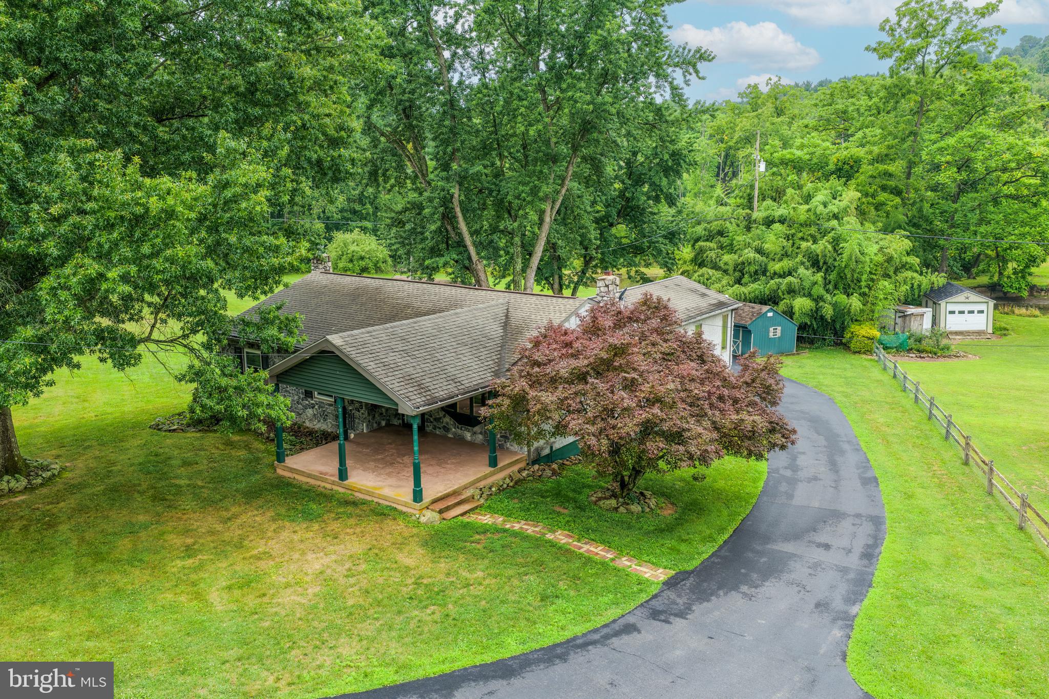 Welcome to your own private retreat! Nestled on over 4 picturesque acres, this beautifully maintained home offers the perfect blend of peaceful country living and comfortable first-floor convenience. Surrounded by breathtaking scenery, the stunning property features a tranquil pond and expansive outdoor space, creating an idyllic setting to relax and unwind.

Inside, you'll find a bright, open floor plan designed for easy living and entertaining. The spacious family room provides plenty of room for gathering with family and friends, while the thoughtfully designed layout offers the ease of first-floor living. Currently configured as a 2-bedroom home, it can easily be converted back to its original 3-bedroom layout to accommodate your needs.
The main floor also boasts a living room, dining area and a large family room situated at the back, overlooking the amazing yard.

Step outside onto the deck overlooking the spectacular backyard and enjoy morning coffee or evening sunsets while taking in the serene views of your own private oasis. 
Beneath the deck is a private patio complete with a hot tub to enjoy this oasis even more.
The finished lower level adds valuable living space, perfect for a recreation room, home office, fitness area, or hobby room.

Completing this exceptional property is a detached two-car garage and the rare opportunity to own over 4 acres of beautifully maintained land. If you've been searching for privacy, natural beauty, and move-in-ready comfort, this one-of-a-kind property is not to be missed. Schedule your private showing today!