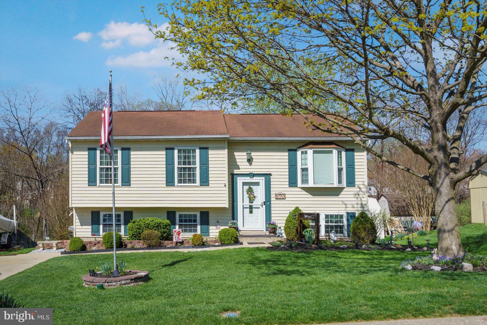 Tons of curb appeal and beautiful landscaping surrounds this pristinely maintained 4BR/2BA expanded split foyer home in a desirable neighborhood.  Pull into your driveway and take in all the beauty as you open the door into your new home.  The entry hall offers you the opportunity to enter the main floor or lower level.  The main floor boats gleaming hardwood floors, and tons of natural light throughout.  On the main floor is a spacious living room, a large dining room with chair railings, the kitchen and a bright and open family room with a vaulted ceiling.  The kitchen offers plenty of wood cabinets and counter space, stainless steel appliances, a copper backsplash, and a pass through into the dining room.  Down the hall are two sizable secondary bedrooms, a full shared bath with access into the spacious primary bedroom.  On the lower level is the fourth bedroom, an office, and a full recently updated bathroom.  Off of the lower level is an oversized sun room leading to the beautiful yard, perfect for entertaining! Completing the lower level is laundry and plenty of storage.  The yard is gorgeous with a lush green lawn, landscaped beds, a patio and a shed.  This home is move-in ready with so much to offer any new homeowner and is conveniently located in close proximity to the community park and playground.  Main street Sykesville, the host to many festivals and activities throughout the year and incredible shops and restaurants, is only a 15 minute walk!