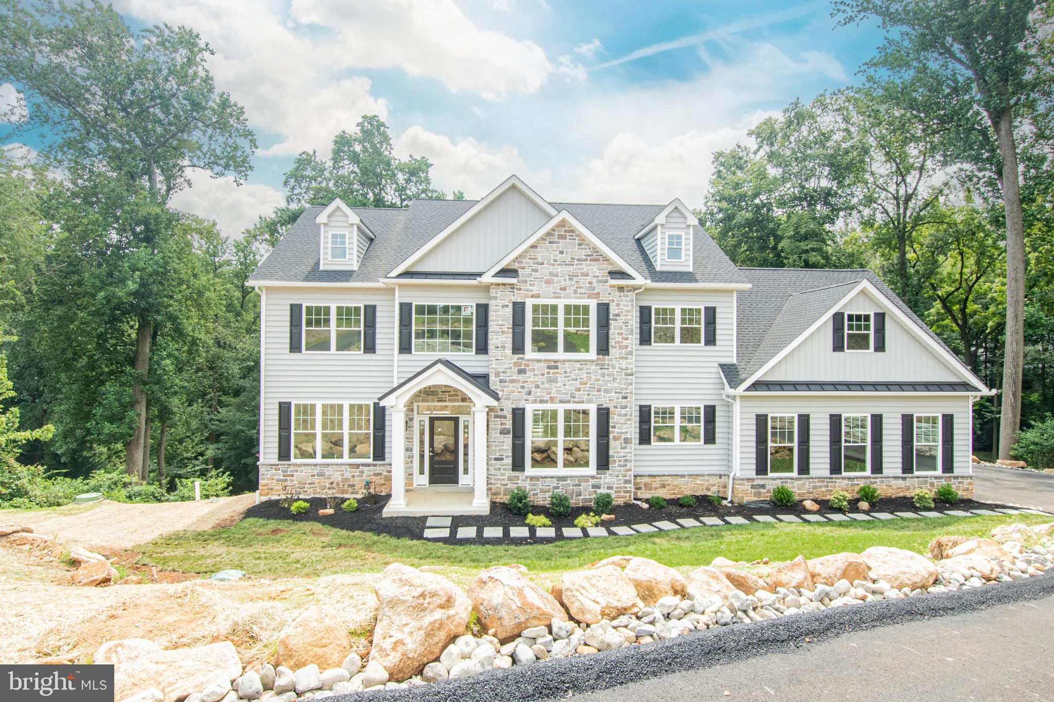 Stunning Custom Colonial on Private .90 Acre Lot — Garnet Valley School District. 5BR 3.5 BA-Welcome to your dream home. Bonus-Free finished basement, Free 2  house length composite decks. No where will you see new construction offer this.  A beautifully crafted custom colonial by the renowned D’Annunzio Builders, locally known for decades of excellence in luxury home construction. This exceptional residence blends elegance, space, and privacy on a .90-acre lot tucked away at the end of a quiet cul-de-sac in a mature, sought-after community, and best of all, there’s no HOA, live as you please. A wide, 11-foot private driveway (wider than standard) leads to a striking exterior featuring stone accents, varied textured siding, and stone walls and stone entrance.The peaceful surroundings offer breathtaking views of trees, a stream, and visiting deer — a nature lover’s paradise. Inside, over 3,650+ square feet. of refined living space welcomes you with a two-story foyer and custom staircase, setting the stage for quality craftsmanship throughout which accents this open floor plan. The main level features wide-plank soft colored hardwood flooring, that will compliment your decor and color choices, elegant coffered ceilings in the dining room, and a stone gas fireplace as the focal point of the family room — perfect for gatherings and cozy evenings.The chef’s kitchen is an entertainer’s dream: abundant custom cabinetry with soft-close drawers, a grand center island, gas 5 burner stove, range hood, SS appliances and a private prep room/walk in pantry, to keep your kitchen pristine. Make those cookies and keep the mess out of sight. High 9-foot ceilings on both the first and second floors and 10-foot ceilings in the basement, lend to the spacious feel and all upgrades that are included.Upstairs, the primary suite offers a spa-like bathroom with a soaking tub, custom tile, and a massive walk-in closet. Three additional bedrooms, a full hall bath, and a convenient second-floor laundry room complete with cabinetry and granite counters complete the upper level.Walk down to the basement on oak stairs which offers a full bathroom, one bedroom and completely finished, 10’ ceilings, walk out and manablock plumbing. Additional upgrades include a tankless water heater, high-end fixtures, and beautifully neutral finishes and tile, flooring and cabinetry throughout. Enjoy outdoor living on your expansive two composite decks that equal 1,040 sq. ft. outdoor living space and include beautiful vinyl railings, already included — a rare feature in new construction to see any decking. Great clean living space that’s so convenient right off the bottom two levels.  3650 square foot living space  (1st &s2nd floors) addt'l square footage listed  is the finished basement estimate.  Professional landscaping and stone retaining walls with drainage enhance curb appeal even further. Located in the sought-after Garnet Valley School District, close to major commuter routes (I-95, Phila. Airport) and top shopping and dining destinations plus close to tax free Delaware. tThis move-in ready home truly has it all.This is the final home in this exclusive five-home development and we truly saved the best for last. Come experience luxury, privacy, and quality craftsmanship all in one extraordinary home and at one incredibly competitive price.