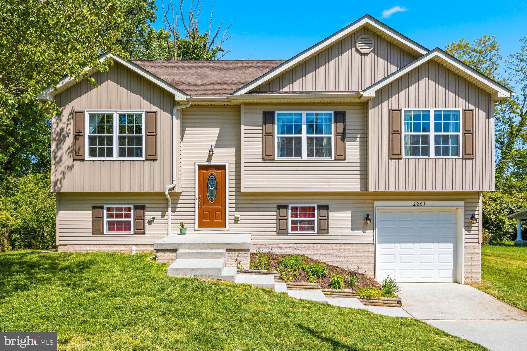 **Seller is setting an offer deadline of Sunday May 10 at noon EST.   Seller will review offers upon receipt and reserves the right to accept an offer prior to deadline** 
Check out this amazing, unique split foyer home, on a large lot, with many updates!  You'll walk into a nice sized entryway that opens up to a main level with cathedral ceilings, spacious open-level living, hardwood floors, and a vibe that you will love.  The main level consists of a separate living room and dining room area both offering plenty of space, plus a huge gourmet style kitchen with granite countertops, stainless steel appliances, tons of cabinetry and a large island space ready for entertaining, relaxing with family/friends or a solo night at home.  The whole house has an open feel, with recessed lights and tons of natural lighting too.  Down the hall, you will find three spacious  bedrooms.  A large primary suite with trayed ceilings, ceiling fan, a walk-in closet, and a modern en-suite full bathroom with shower and ceramic tile finishes.   Bedroom two and three are also good sizes and share the hall bathroom which has a tub/shower combination, and ceramic tile finishes.  Out back you will find a wood deck and a nice yard.  Heading downstairs, you will find spaces that don't feel like a basement, with raised ceilings, a large, open family room, a slider to the rear yard, lots of storage space and new carpeting, This basement is well lit and A+.  You will also find a separate laundry room with a double load washer, and builder included radon remediation system.  To the rear of the basement, a bedroom / full bath combination that is perfect for you or for guests.  The house also has an attached garage and driveway that walks into the basement and plenty of street parking out front - the second refrigerator in the garage will transfer.  This house is in the high demand area of Woodberry, near to Hampden, the Maryland Zoo, the Jones Falls Trail and the light rail.  Uniquely located on Park Hill Ave, which is a quiet tucked away neighborhood loop road that will have you feeling removed from the city crowds, yet still conveniently located with excellent accessibility to major highways/roadways (83, 40, 1, 695, Falls Rd), restaurants, shopping, entertainment and more.  Come fall in love and make this home yours.