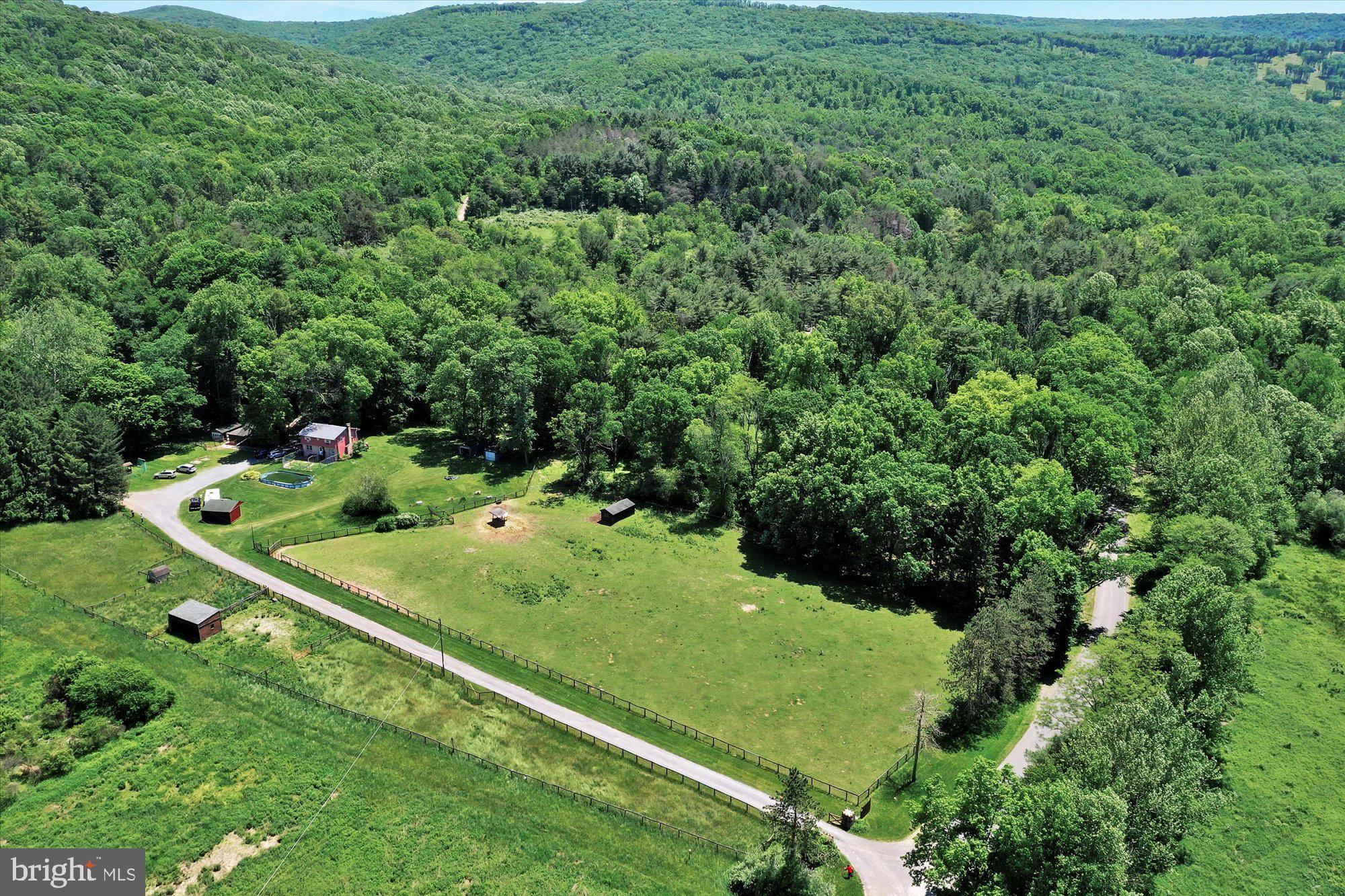 Welcome to Patchwork Farm!  Get back to nature on this 10+ acre farmette located at the base of Hawk Mountain, with a stream running through it and direct access to state gamelands.   This 4 bedroom home needs a little love and revitalization but the work can be done while you live there.  Enjoy farming, horses, hunting or just simply relaxing by the stream.   Also located on the parcel is a mobile home with a rent-paying tenant.    (Mortgage options for this property are limited due to the 1963 mobile home.  Likely to be a cash only sale. )