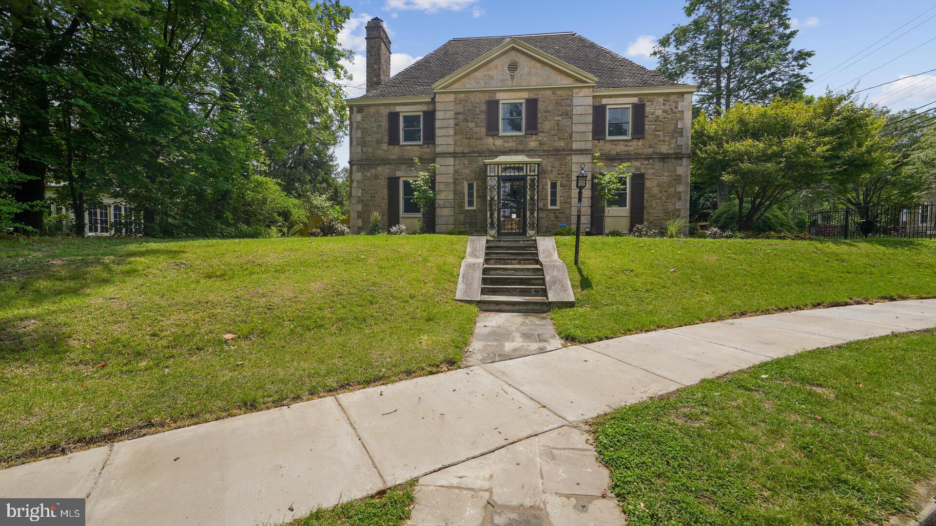Beautifully renovated 6 bedroom, 3 bath, 2 powder room house in a gated community. Over 5,000 square feet of living space on the top 3 floors. Finished basement has a knotty pine bar with fireplace and powder room. Grand entry foyer with circular staircase. Library with built-in shelving and a fireplace. Extra large living room with fireplace and two exits to the back yard. Décor kitchen with quartz countertops and tile floor, 2 sinks and an exhaust vented to the outside. Dining room with outdoor exit. Master bedroom with fireplace, master bath and rooftop deck. Three other bedrooms and a bath finish the second floor. Third floor has two bedrooms and a full bath. Large closets. Completely refurbished pool with blue stone decking and new pool equipment. Pool house with two full baths and a kitchenette. Detached 2 car garage. Two zoned heat and central air. Refinished hardwoods throughout. Screened-in porch. Replacement windows.