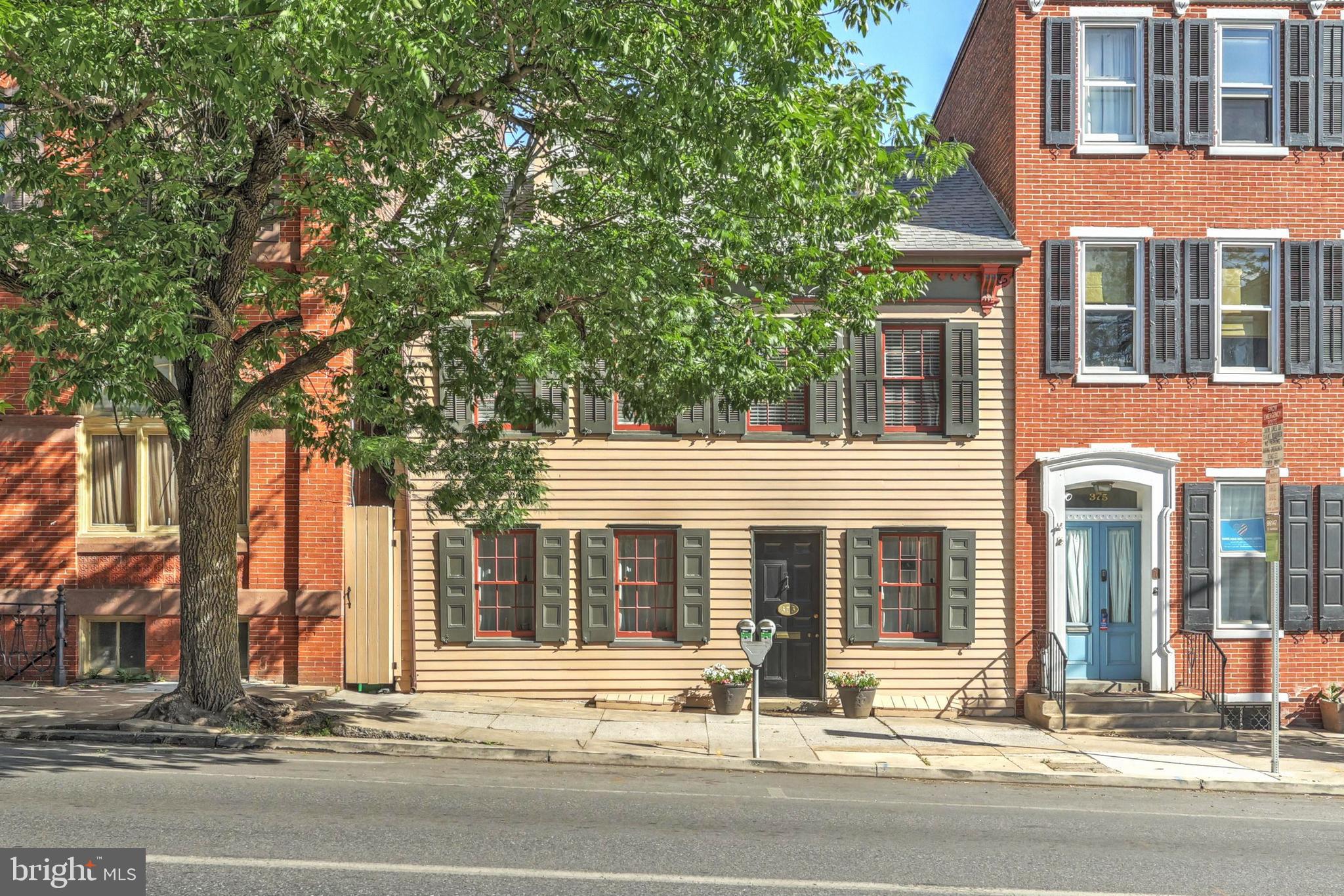Elegant colonial in Historic District of York City, filled with modern amenities while still preserving the era of the home. Beautiful entryway with fireplace mantle and terra cotta floor, each room lovingly detailed with chair rail and crown molding, wood floors, bay window in the kitchen overlooking the stunning rear patio and garden! Spacious bedrooms, one with skylights and built ins  and all with wood floors.   Fenced yard with rear parking for four cars. This home is beautiful and is a must see if you're thinking of city living and being close to all that Downtown York has to offer.
