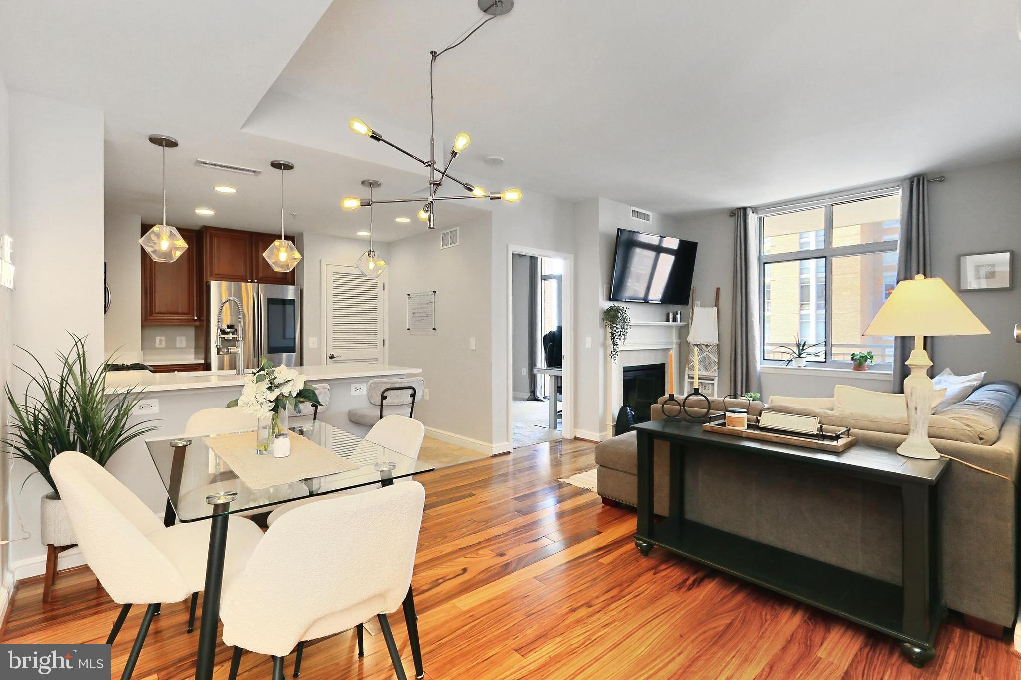Experience luxury living at the Midtown at Reston Town Center. Located in the heart of Reston, this one bedroom one bath, plus bonus Office, condo is designed  for comfort and style with its great location, amazing amenities and stunning design. The open concept floor plan promotes room to entertain while remaining cozy and charming. The Kitchen will delight with new countertops, gas cooking, plenty of storage and counter space. The adjacent Dining area allows for a large table and flows into the Living Room with hardwood floors and a fireplace. The large Primary Bedroom adds extra private space and boasts a nice Full Bath and double closets.  The Bonus Room/Office provides excellent space for your individual needs and leads directly to the over-sized private balcony overlooking the pool with views of the city and out west to the sunset. The resort-style amenities at Midtown at Reston Town Center include: 24-hour professionally staffed concierge and doorman, state-of-the-art fitness center, Library, private movie theatre, outdoor swimming pool and grilling terrace.  Elegance meets convenience with the close proximity to premier shopping, fine dining, movie theatre, parks and summer concepts.  For your local or long-distance travel, it is near the Metrorail Station, many commuter routes and Dulles International Airport.  Welcome Home!