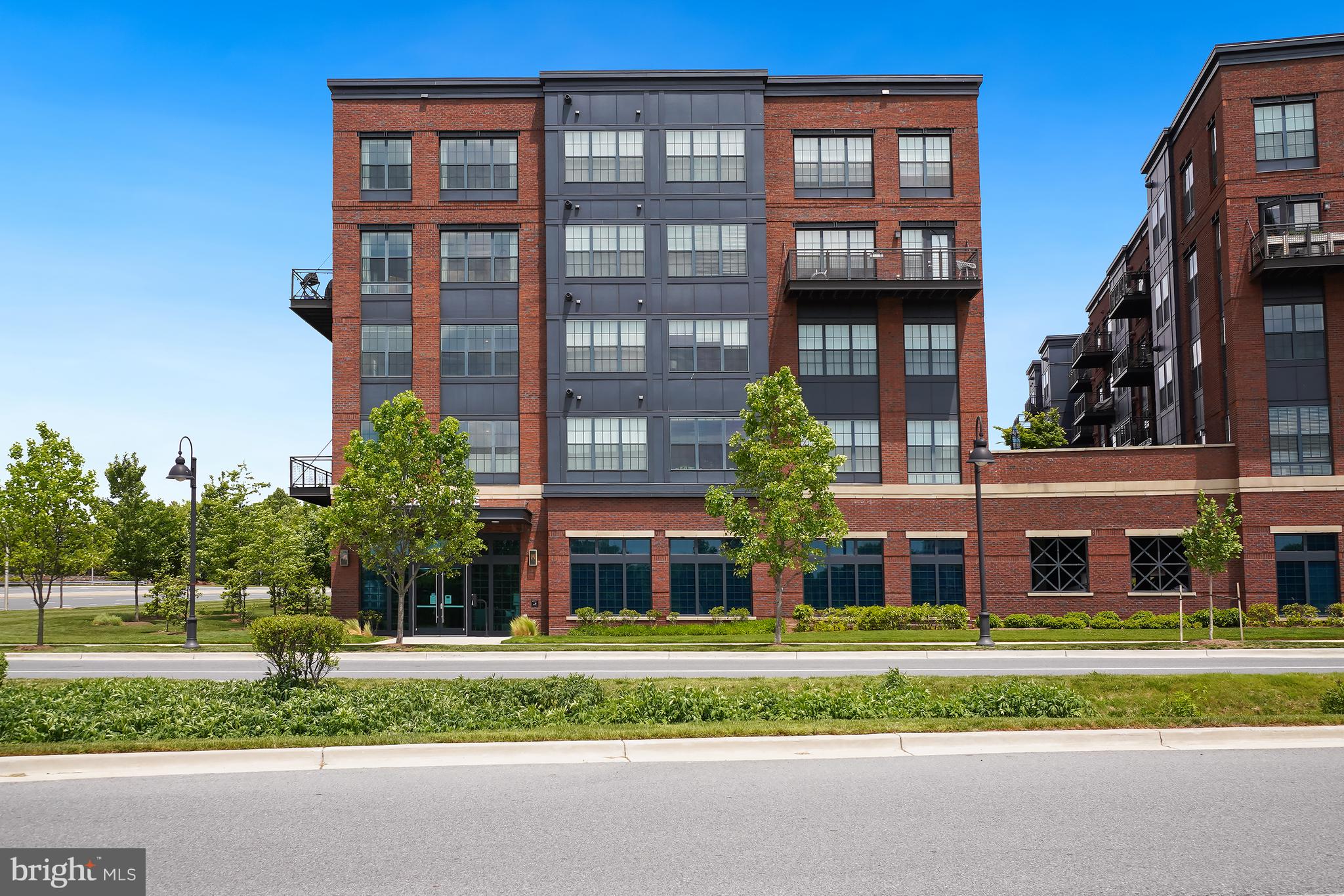 Welcome to this stunning condominium in the highly desirable Downtown Crown community of Copley at Crown. Ideally situated in the heart of a vibrant, walkable neighborhood, residents enjoy immediate access to shopping, dining, and entertainment, including Harris Teeter, Starbucks, LA Fitness, and countless restaurants and boutiques. Just minutes away, Rio Lakefront offers additional shopping, entertainment, waterfront dining, Target, and AMC Theatres.

This exceptional two-level residence features 2 bedrooms and 2 full baths, along with dedicated garage parking and a private oversized storage unit conveniently located directly next to the unit entry. Residents enjoy added peace of mind with secure building and garage access requiring key fob entry. Welcoming entry with hardwood flooring throughout the main living spaces. The main level includes a spacious secondary bedroom and full bath, along with a versatile Murphy bed system that conveys and doubles as a built-in desk offering flexibility for guests or a home office setup.

The dramatic two-story great room is filled with natural light from soaring floor-to-ceiling windows and enhanced by custom two-story draperies and motorized Hunter Douglas Silhouette blinds in both the great room and upper loft area. A private outdoor balcony located just off the great room provides the perfect space to relax or entertain. The gourmet kitchen is beautifully appointed with stainless steel appliances, quartz countertops, and an oversized island with breakfast bar seating, all opening seamlessly to the main living area for effortless entertaining.

Upstairs, the loft overlooks the great room below and leads to the private primary suite featuring custom Hunter Douglas Honeycomb top-down darkening shades. The upgraded primary bath includes a luxurious gooseneck rain shower and Toto Washlet toilet. Every closet throughout the home, including the storage unit, has been thoughtfully customized with California Closets systems, offering exceptional organization and storage solutions throughout this sophisticated urban retreat. Schedule your showing today!