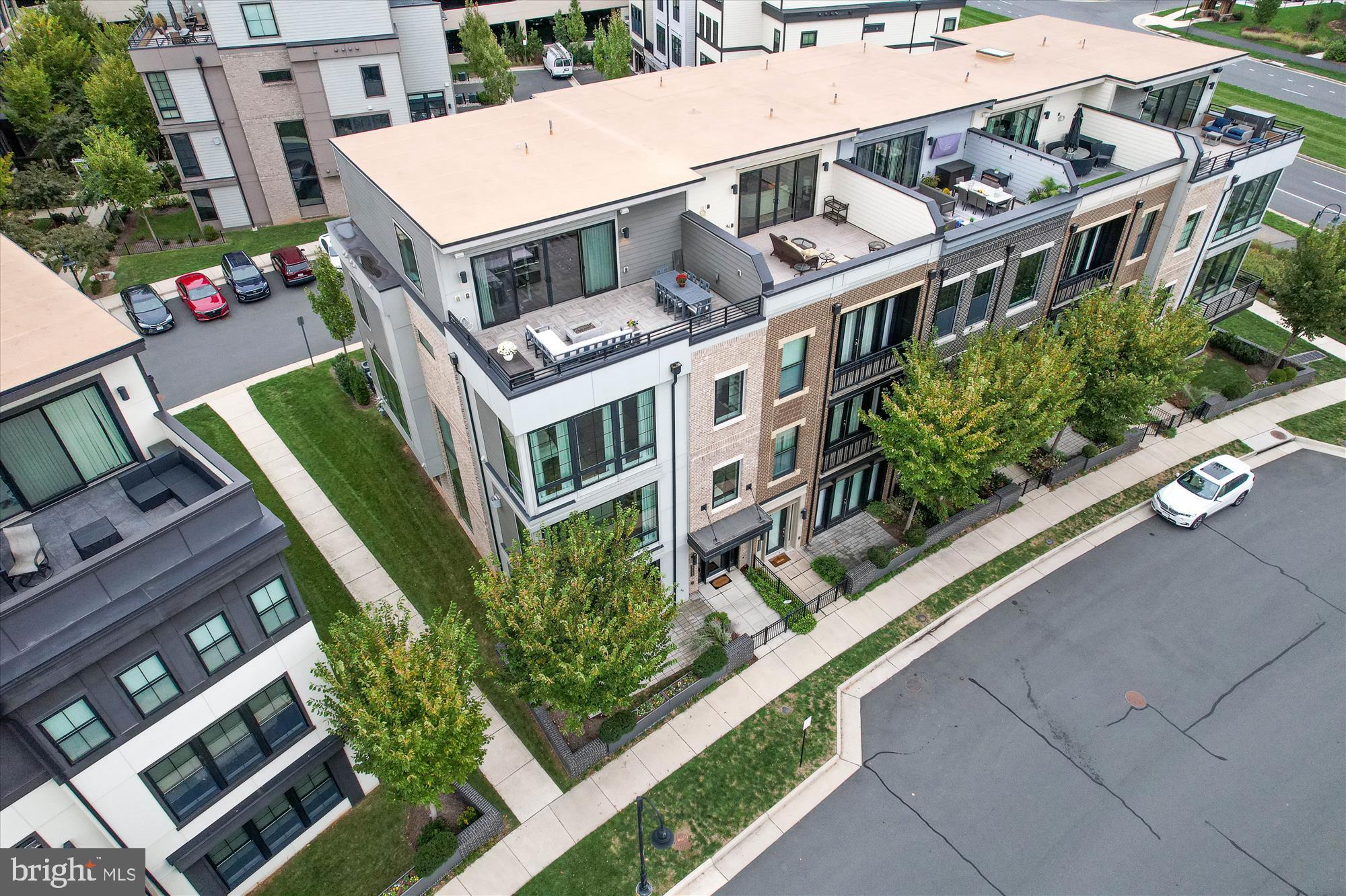 Rarely available, a very special, luxury end-unit townhouse by Miller & Smith with a private elevator facing One Loudoun's Central Park.  This magnificent home is simply stunning with upgrades and designer touches throughout.  The chef's kitchen is magazine worthy with Wolf and Sub-Zero appliances including a custom wine refrigerator, built-in coffee/espresso machine and a 13' island with quartz countertops with a waterfall edge.  Noteworthy architectural details are sure to impress with floor to ceiling windows, high-end cabinetry and built-ins, 10' high ceilings, Lutron motorized shades, wide-plank engineered wood floors, upgraded railings, designer lighting and multiple outdoor living spaces. The 1LX floor plan is ideal for living and entertaining and features 4 bedrooms, each with a professionally organized closet and an en-suite bath as well as 2 powder rooms and a main level office.  The primary suite offers views of the park and boasts a spa-like primary bath with radiant heat stone floors, a walk-in shower, separate soaking tub, electric mirror and quartz counter tops.  Retreat to the upper level loft and you will be amazed by the spectacular rooftop terrace with panoramic views with wood tile flooring, a gas fire pit and motorized awning.  The spacious and light-filled loft area is an welcome retreat with built-in cabinets and a beverage refrigerator, ideal for a home office or for entertaining.  There is ample storage throughout with the custom cabinets in the laundry room and in the mudroom, as well as additional wall mount storage cabinets in the garage, complete with EV charging and an epoxy floor.

One Loudoun is a unique place of sophisticated culture and urban-inspired architecture located in the heart of Loudoun County, VA at Rt. 7 and Loudoun County Parkway.  Comprising 358 acres, the community integrates a town atmosphere with great neighborhoods and an exciting downtown of retail, dining and entertainment.  One Loudoun Neighborhood Association amenities include a resort-style Clubhouse, outdoor pool, tennis courts, pickle ball courts, half-court basketball, sand volleyball, meeting rooms, 3 playgrounds, and a "Central Park" which includes The Barn at One Loudoun, an amphitheater and barn venue that hosts community social events.  Stroll along the beautifully designed streetscapes to visit your favorite boutiques, dine at a wide variety of restaurants and bars, or enjoy a community event on the Downtown Plaza.