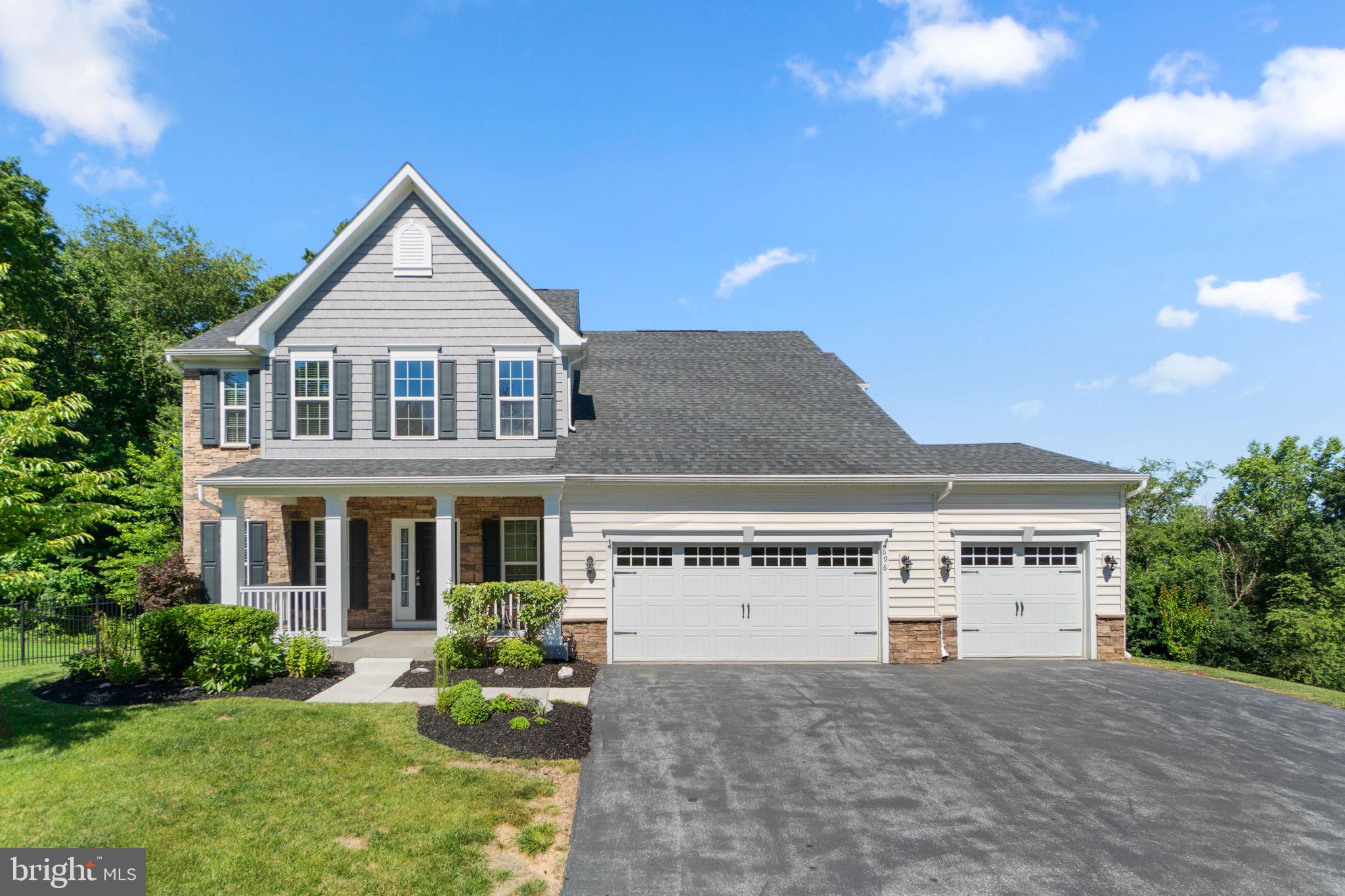 Elegant NV Homes Colonial built in 2018, offering 3,296 finished square feet with picturesque pastoral views in desirable Bolton Hill. Freshly painted and featuring newly installed carpet in 2026, this beautifully maintained home showcases timeless finishes, spacious living areas, and a thoughtfully designed floor plan ideal for everyday living and entertaining. // Hardwood floors span the traditional main level, beginning in the welcoming foyer with a convenient powder room. To one side, the formal dining room is enhanced by chair railing and an elegant chandelier, creating the perfect setting for gatherings and special occasions. // Continue into the stunning eat-in kitchen, beautifully appointed with upgraded countertops, an oversized center island with breakfast bar seating, stainless steel appliances, abundant white shaker-style cabinetry, and generous workspace. A sun-filled breakfast room with vaulted ceilings, panoramic windows, and deck access provides the perfect place to enjoy morning coffee while taking in the scenic views. // Open to the kitchen, the spacious family room is anchored by a dramatic floor-to-ceiling stone gas fireplace, creating a warm and inviting gathering space. French doors lead to a versatile main-level bedroom, ideal for guests, multigenerational living, or a private home office. A mudroom with garage access completes the main level. // Recently installed carpeting extends throughout the upper level, where four generously sized bedrooms await, including the luxurious owner's suite. This private retreat features a walk-in closet and a spacious ensuite bath with a dual-sink vanity, soaking tub, separate shower, and private water closet. A second full bathroom and a conveniently located laundry room complete the upper level. // The walk-out lower level offers exceptional flexibility with an expansive recreation room, a full bathroom, a large storage room ideal for a workshop or hobby space, and a utility room. // Outdoor living is equally impressive with a long covered deck featuring two ceiling fans and peaceful pastoral views overlooking the tree-lined backyard. Partial fencing adds privacy while preserving the tranquil natural setting, making it an ideal space for relaxing or entertaining. // Select photos have been virtually staged for illustrative purposes only.