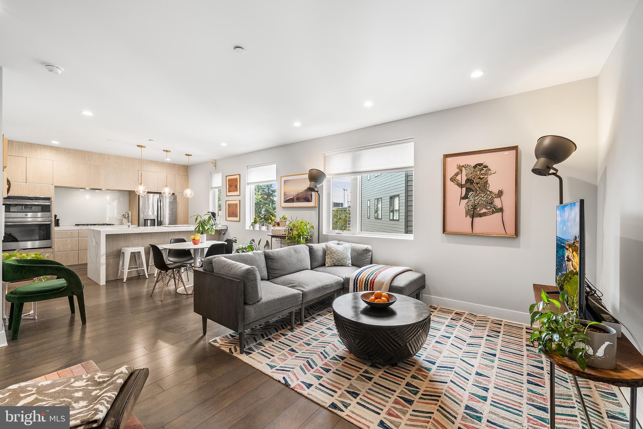 Your perfect piece of Fishtown awaits at Penn Treaty Residences- a hip, 30-unit condo building in the heart of Philly’s trendiest neighborhood. Completed at the end of 2018, unit #403 is a spacious 2 bedroom, 2.5 bathroom, sun-filled bi-level condo with 1 car covered parking! No detail has been overlooked in this modern, impeccably maintained property. Upon entering, you’re greeted with gleaming wood floors, tall ceilings, expansive windows and a breezy open layout. The chef’s kitchen features sleek, low profile cabinetry, an oversized walk-in pantry and a waterfall quartz island providing plenty of counter space and additional seating (for 4). The kitchen flows naturally into the large, sun drenched dining and living room complete with a cozy electric fireplace and convenient half bathroom. Upstairs is a smart layout featuring 2 sizable bedrooms and 2 full bathrooms. The sunny primary bedroom is a relaxing retreat with a large custom walk-in closet and en-suite bathroom with a beautifully tiled shower. The well-sized second bedroom has a big closet and utilizes the second full bathroom with deep soaking tub accessed from the hallway. Stacked, full-size laundry is also neatly tucked away between the bedrooms on this level. Clean lines and pristine finishes sum up this unique condo- one of only 2 bi-level units in the association and it’s location at the back of the building keeps street noise at a minimum. This stunning condo unit also includes a highly coveted, covered 1 car parking spot (with dedicated EV charger) in a secure central parking lot located within the building’s courtyard. Additional amenities include a storage locker (on lower level), bike and scooter storage room, elevators, secure intercom entrance and access to the common roof deck to enjoy 360 degree city and bridge views. Penn Treaty Residences is a professionally managed, pet-friendly building located on bustling Frankford Avenue and steps from several parks, an Indego bike station and a stone’s throw from public transit and easy access to I-95. Take advantage of all of Fishtown’s dining, drinking, entertainment and fitness hot spots like Suraya, City Fitness, The Fillmore, Pizzeria Beddia, Kalaya, Next of Kin cocktail bar, and La Colombe. You’ll have the best of the neighborhood at your finger tips while enjoying low maintenance living for years to come.