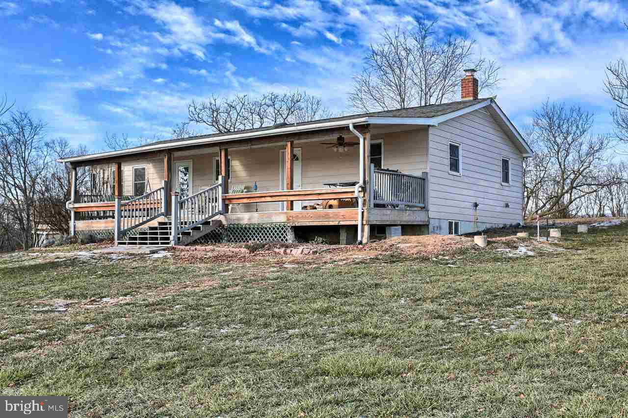 Lovingly cared for home on 10.8 acres, 5 fenced paddocks, two outbuildings with water and power. Enough space to raise animals or cultivate crops. The kitchen features butcher block counters and is open to the living room where you can stay cozy next to the wood stove.  The lower level has a family room, a bedroom, and a bathroom with a jetted tub to relax in. This beautiful home also has a workshop, a canning room, and 2 decks.