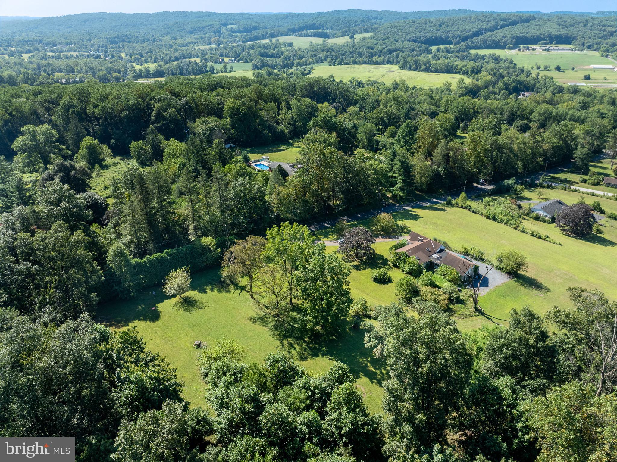 Opportunities with breathtaking views! Located in highly desirable Chester County within the Owen J. Roberts School District, this 2-bedroom, 1-bath ranch home with an attached 2-car garage sits on 5.8 scenic acres in South Coventry Township. The property offers a rare opportunity for homeowners with the potential to be subdivided into three total lots for new construction (see subdivision map in Documents). Situated atop the Coventryville Road ridge, the property boasts outstanding views overlooking Warwick Park and the surrounding valley. The mostly flat lot features a sprawling yard, partially wooded acreage, and plenty of privacy, while the home provides a functional layout ready for updates and personalization. Call today to schedule a showing and take time to check out the view!