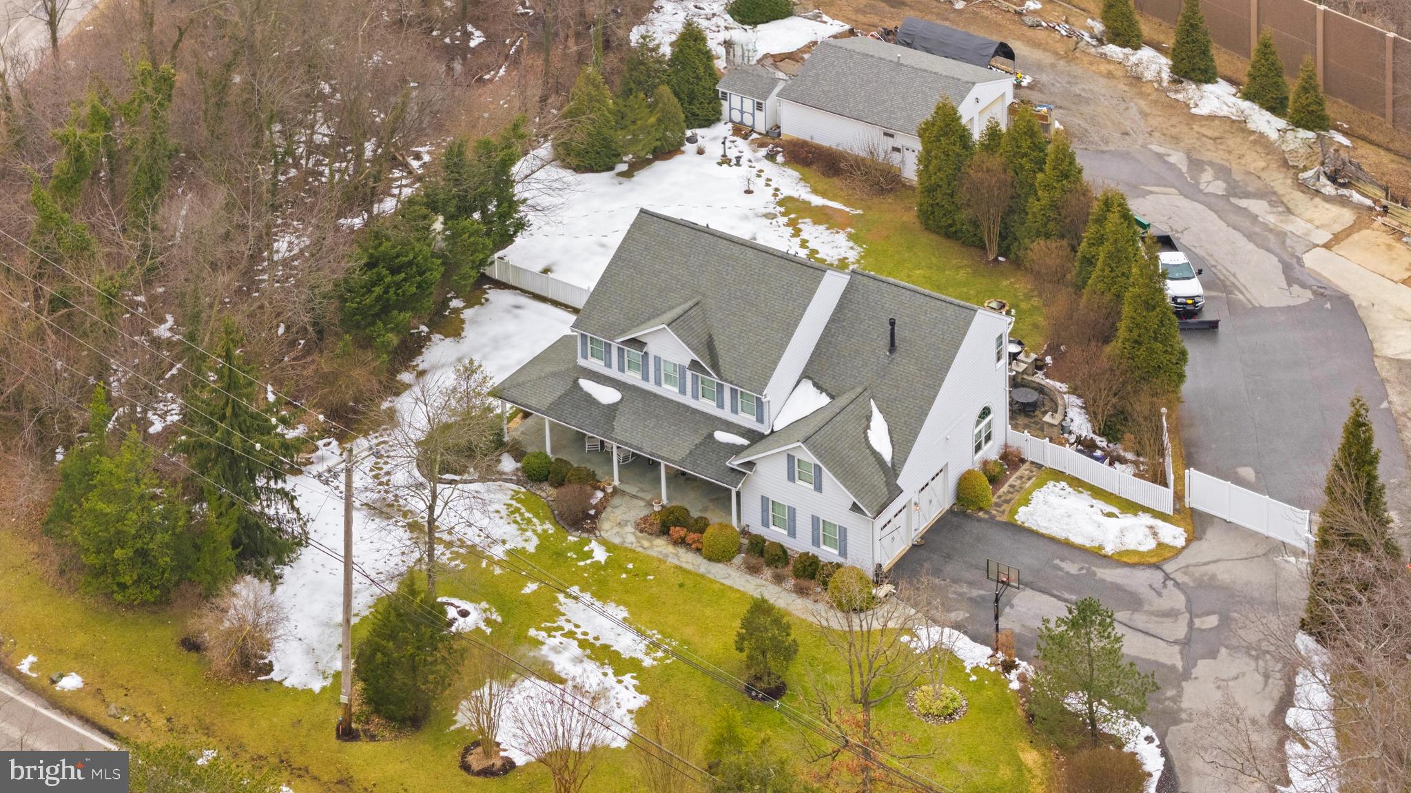 ONE OF A KIND OPPORTUNITY! This is one of those properties that never comes on the market, truly a unicorn listing. Custom built by original owners – first time to the market! This spacious colonial style home offers 4 bedrooms, 3.5 bathrooms, attached 2 car garage sitting on a 2+ acre lot with a 32 x 28-foot detached heated structure on the backside of the lot separated by a white vinyl fence. This 28x32 shop + yard could appeal to many different business owners - landscaping, towing, catering, home improvement, tree removal, plumber, car mechanic, electrician, welder, painter, house cleaning, etc. Calling all car and vehicle enthusiasts or hobbyist – here's the detached garage of your dreams. Let’s talk about the home itself. With a charming covered wrap around front porch and professional landscaping, this home has major curb appeal. Inside offers over 4,000 square feet across 3 finished levels. As you walk into the foyer, you’ll see a formal front sitting room and dining room. Continue on to a gorgeous open concept kitchen and living room space. Kitchen cabinets have been freshly painted and newer appliances. The living room has beautiful custom built in shelves around a gas fireplace. Back door leads to an expansive stone paver patio and fully fenced in flat back yard. The main level also has dedicated office and ½ bathroom. Upstairs offers 4 bedrooms and 2 full bathrooms. The primary suite is a DREAM. Gorgeous shiplap walls and vaulted ceilings with multiple walk in closets. The master bathroom was fully renovated (2019) and checks every box – soaking tub, huge vanity, stand up shower tile, etc. The massive basement is fully finished. Imagine hosting for Ravens games with the full bar set up. Plenty of space to meet all your needs – even an additional bedroom could be created. There is a full bathroom down there. Major systems have been replaced – roof (2016), HVAC (2016), HW (2011), most windows have been replaced. Located in Elkridge (Howard County) offering the perfect central spot for businesses – easy commute to Baltimore City, Baltimore County, and Anne Arundel County. Bonus – NO HOA! Contact listing agent for more information! Please do not walk on property without a scheduled appointment with agent.
