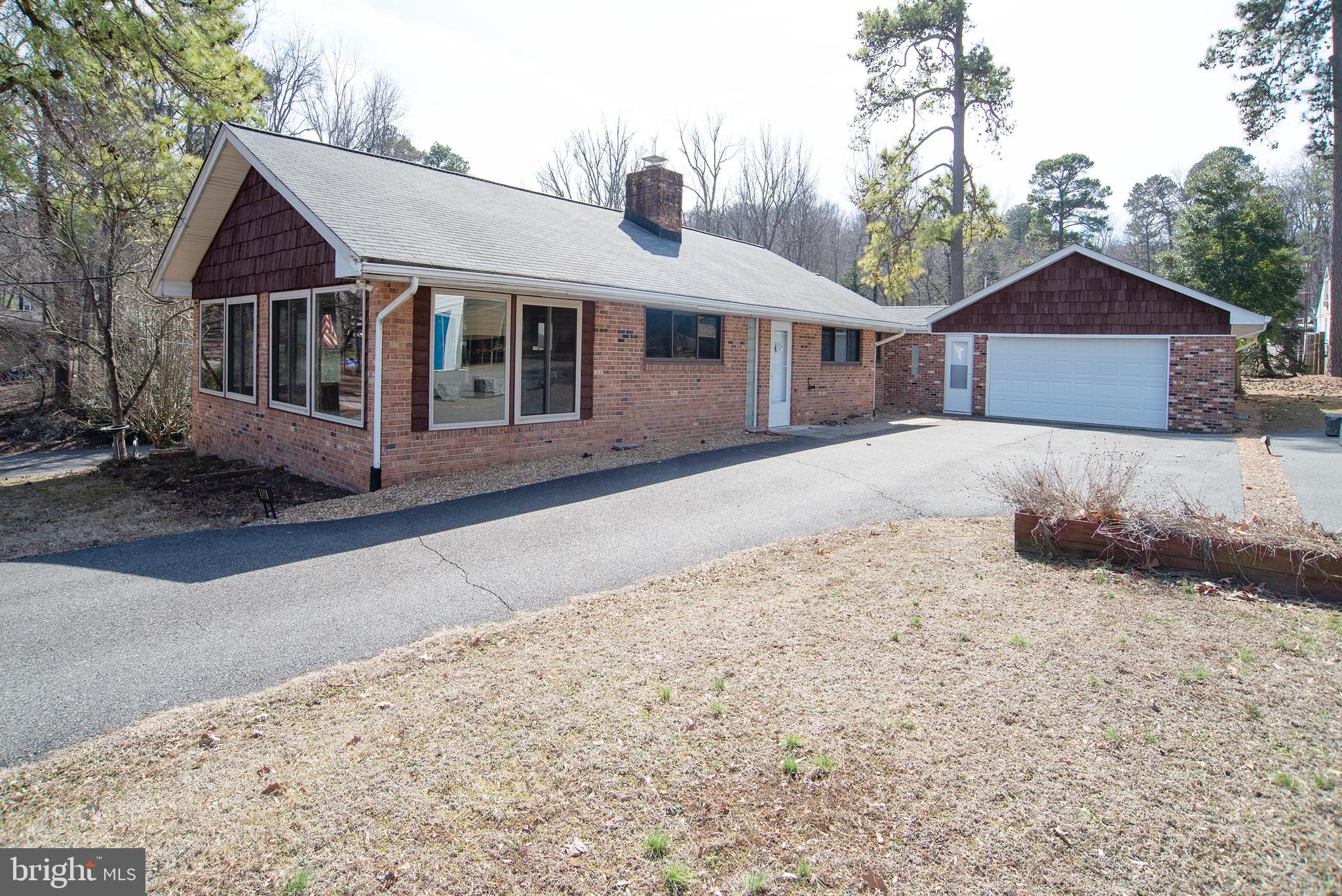 Nice brick home in waterfront community; with view to the Potomac River.  This lovely home has living room w/beautiful stone fireplace; large family room w/lots of glass for viewing of water across street; 2 baths, 3 bedrooms; kitchen w/stainless steel appliances; 2-car oversized garage; paved driveway; fenced backyard;  The homes interior has been professionally painted walls and ceiling, with new toilets installed in both bathrooms, Re-stained Exterior Shaker siding, and shutters.  Power washed, Plus Central Air and heat throughout.  Easy commute to Fredericksburg & DC area; Make it your get- a-way or year-round home.   
The homes neighborhood adjoins Westmoreland State Park to the East, And Horner's Beach, to the West. Both Colonial Beach and the Rt#301 Bridge are both visible to the West from the beach.
