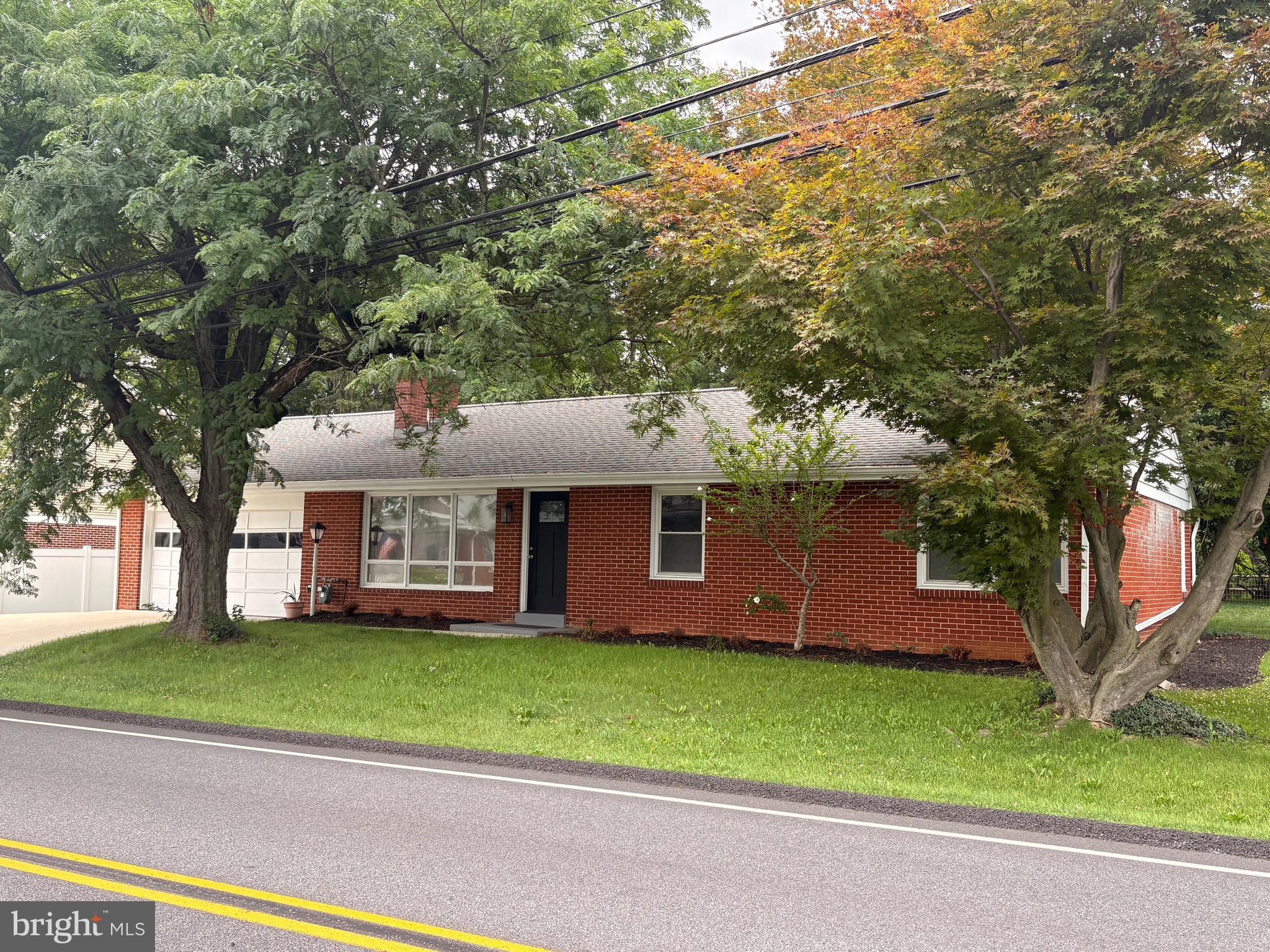 This move-in ready home is located in the heart of the Hershey Village.  It is walking distance to school, the recreation center and in-town shops and restaurants! Plus it comes with all the amusement park perks enjoyed by adding a villager pass endorsement to your season passes! As you enter, the light and bright living room you'll enjoy a cozy fireplace- an ideal space to read a good book or relax with friends. The open kitchen, dining area and family room make entertaining a breeze! The breakfast bar provides a good spot to have quick meals or complete homework and ample counter space helps with meal preparation. The large primary bedroom has an en-suite with a walk-in shower.  Two additional good size bedrooms and another full bath round out the ground level. The lower level offers a large family room with a bar for entertaining, a private room for an office or small gym, a full bathroom, and large storage rooms. With 2610 sq feet of living space, there is something for everyone. The home comes with all appliances, an integrated home security system, and an optional newly installed stair lift. Enjoy outdoor living? The large covered patio and fenced yard with ample shade trees, established raspberry bushes, and constructed garden beds, will be the place for you! Barbecue or enjoy listening to Hershey's Summer Concerts from your own backyard. Located in the desirable Derry Township/Hershey School District and approximately 1 mile to Hershey Medical Center, schedule your showing today! Home is virtually staged in some photos.