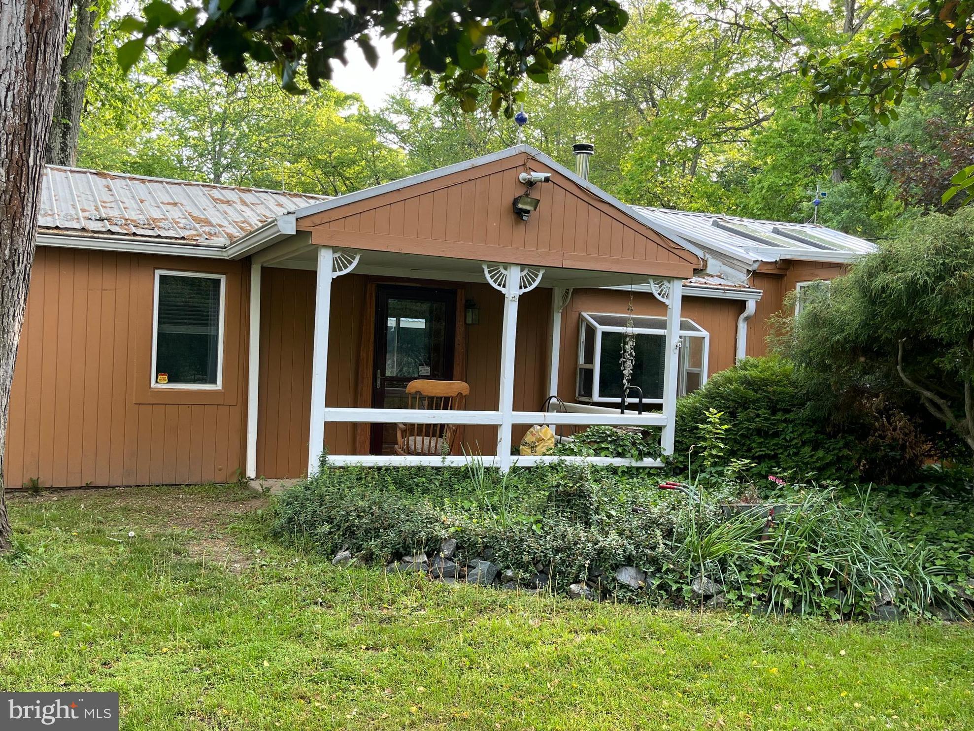Welcome to 143 Shady Beach – A Hidden Gem in North East!

This unique 2-bedroom, 1-bathroom home sits on a beautifully landscaped and fully fenced 1.85-acre lot, offering both privacy and space to enjoy the outdoors. Just minutes from the heart of North East, local marinas, and Little League fields, the location is ideal for both convenience and recreation.

Perfect for pet lovers, the expansive yard is entirely enclosed, making it a safe haven for your furry friends. Step outside to enjoy year-round blooms in the vibrant gardens, unwind by the tranquil koi pond, or take a dip in the refreshing above-ground pool. An outdoor campsite adds a touch of adventure, ideal for evening bonfires or weekend get-togethers.

The property also features a large garage equipped with a 12,000-pound car lift—perfect for auto enthusiasts or those who love to tinker. Plus, a spacious two-story Quonset Hut provides ample storage, workshop potential, or creative space.

This is not your average home —143 Shady Beach is a lifestyle. The owner is seeking someone who will appreciate and care for all the unique features this one-of-a-kind property offers.