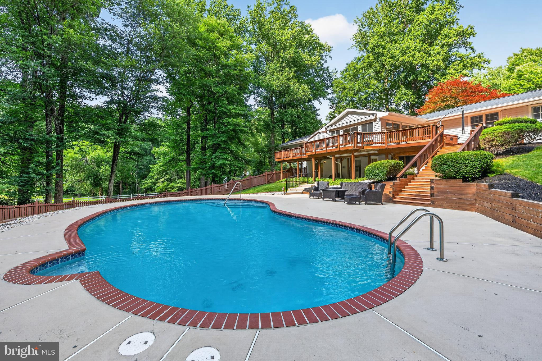 Welcome to this exceptional home in the community of Hickory Meadow. Offering 4 bedrooms, 4.5 bathrooms, and situated on a private 1.33-acre corner lot, this property combines spacious living with outstanding indoor and outdoor amenities. The beautifully renovated kitchen is the heart of the home, featuring a large center island, quartz counters, abundant cabinetry, and an open flow to the adjacent living room, dining room and adjoining family room. Sliding glass doors lead to the expansive rear deck overlooking the private in-ground pool and lush backyard.  A main-level mudroom and laundry room provide direct access to both the attached garage and rear yard. The finished walkout basement adds flexible living space with direct access to the backyard. An attached two-car garage, ample driveway parking, and a propane generator complete this impressive Hickory Meadow property.