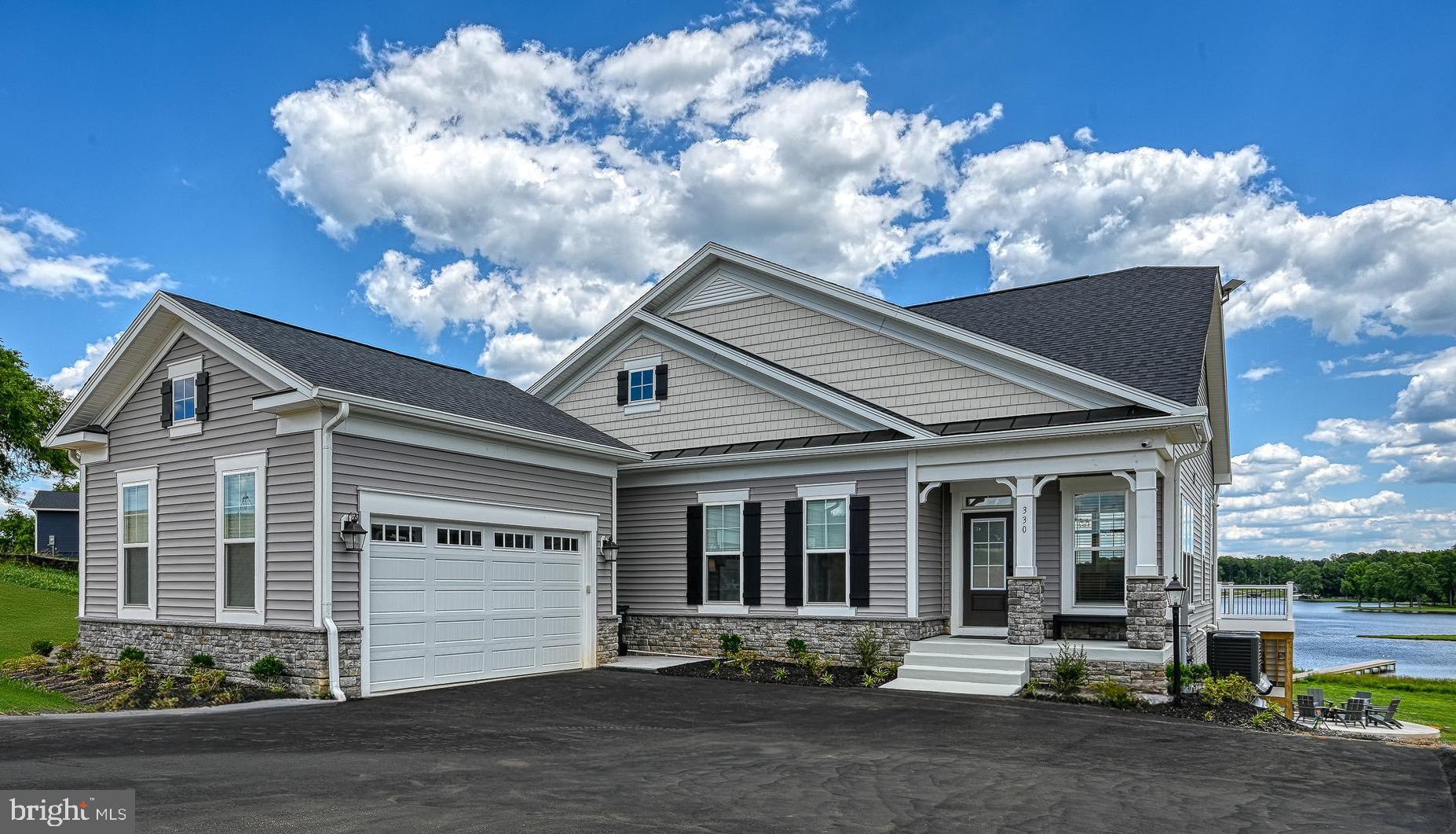 An exceedingly rare blend of lakeside luxury and superb investment opportunity, this striking waterfront home was recently built (2024) in the new and popular Rock Island Landing community, located on the exclusive private side of Lake Anna, Virginia.  Rental income forecast: $250,000 per year!  See attached income forecast for details.  This turn-key immaculate compound comes 100% furnished, offering 7 large bedrooms, 5 bathrooms, high speed FIBER internet available (Firefly), a stunning massive kitchen, large finished basement with games, all sprawling across 5,500 square feet of beautifully finished living space on 3 levels. This perfectly-maintained lake house offers water views that recharge the soul, and rivers of passive income that will fill your coffers.  Already a high-producing short term rental home, this home can be a turn-key income producing asset, or an escape into relaxing lakefront living.   The main level is thoughtfully designed around an expansive great room with high ceilings, refined LVP flooring, and large floor-to-ceiling windows showcasing beautiful views of Lake Anna.   Everything in the open kitchen is high-end, including its quartz countertops, stainless appliances, the massive island, extensive soft-close cabinetry, and refined pendant lighting.  The large primary bedroom suite is on the main level, offering lake views and en suite bathroom, including double vanity, standalone tub, and walk-in shower.   The main level also features a second bedroom with bathroom, walk-in pantry / storage room, laundry room, mudroom, and large attached two-car garage.  Upstairs your guests and family members will enjoy three additional large bedrooms, beautiful custom built-in bunkbeds, and 2 bathrooms.  Downstairs, the massive finished basement is a show-stopper; complete with kitchen/wet bar, game rooms with pool table, basketball, arcade games, unfinished storage space, and more.   The back deck overlooking the lake is giant; constructed with maintenance free composite decking - the perfect spot to relax alone or entertain, many while enjoying the incredible water views.  Warm your spirits at the new fire pit on prime hardscaping, perfect for making memories under the stars.   This property features 100 feet of prime waterfront shoreline, your very own private boat dock for swimming, fishing, sunbathing, and mooring your boat.  Enjoy the large hot tub with friends, and then grab the kayaks to explore the lake.   Extra-large septic system already installed, perfect for a busy short term rental home with many guests.  Being on the private side of Lake Anna also means comfortable water temperatures that extend the boating and swimming season, making this property a standout for both personal use and year-round income potential.  Perfect location: just minutes from groceries, restaurants, The Lake Anna Taphouse, vet clinic, ice cream, coffee, and more.  Conveniently just 45 minutes to Richmond, Charlottesville, and Fredericksburg, and only 90 minutes from Washington DC.