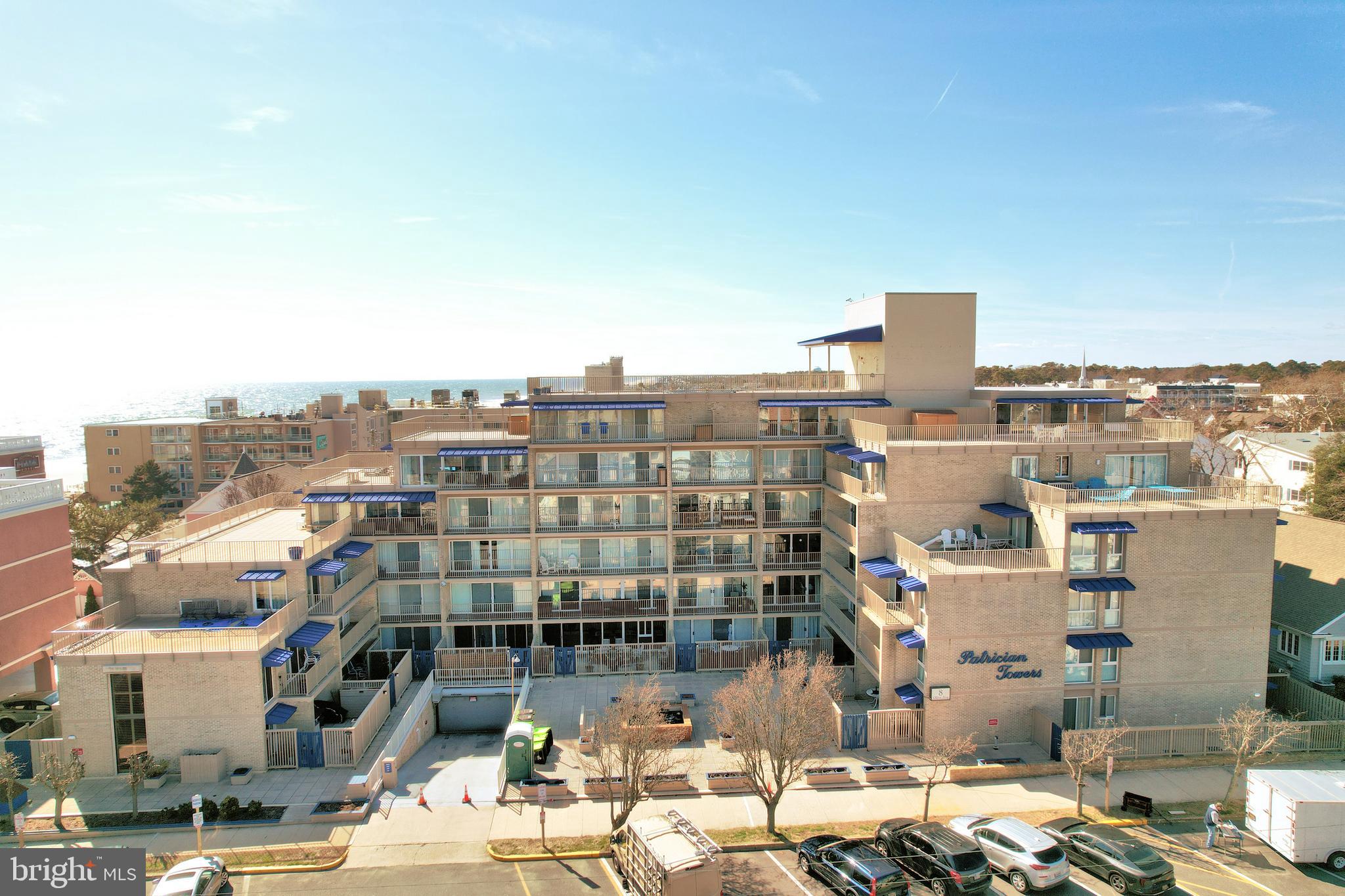 Ocean View - Ocean Block & Rarely Offered -  MOTIVATED SELLER! This 2 bedroom, 2 bath condo is ready for it's new owner.  Located on the first floor, this unit can be accessed through the lobby, or through a secondary entrance located on the side of the building. The first floor condo is offering a updated kitchen with SS appliances, quartz countertops & undercounter LED lighting, dining & living area with fireplace and also a Queen size murphy bed along with a great patio area off the living area. In the dining area you will note a beautiful 16ft floor to ceiling window allowing a lot of natural lighting to flow in. On the first floor there is also a nice sized storage/pantry closet. The Fireplace will keep you warm on the cooler evenings and add a nice touch  of ambiance.  Where the fireplace is located  offers additional storage as well. The 2nd floor offers a primary bedroom w/ full bath along with a covered balcony overlooking the courtyard with Koi pond and also the ability to enjoy sunset views.  Enjoy the 2nd covered balcony on the upper level with a great view of the Atlantic Ocean and the famous Rehoboth Beach Boardwalk.  Guest bedroom with access to the hall bath.  Both bathrooms have been updated.  New electric box - 2 zone heating and AC have been within the last 3 years.  4 Storm Shutters were added to protect you from the elements or simply as added protection through a storm. Freshly painted! Enjoy one parking space in the secure underground heated garage. Patrician Towers has a welcoming courtyard with Koi pond, a great place to gather with friends and family before an evening out. After a day on the beach, take the elevator up to the roof top pool with panoramic views of the ocean, boardwalk and the city. Sunrises and sunsets from there are not to be missed. If you enjoy biking, Rehoboth is home to the Breakwater Junction Trail, known for its natural beauty and proximity to historic Lewes and beyond. Bike storage is located in the garage.  In recent years, Patrician Towers has undergone major renovations to the building to maintain its structural integrity, improve appearance and protect the investment of its owners. These include new aluminum awnings; aluminum railings, balcony and walkway coating; brick pointing; concrete repairs; caulking; soffit coatings; drip edge replacement and more! All phases were completed prior to May, 2023. There is a 1% Capital Contribution Fee at the time of closing.