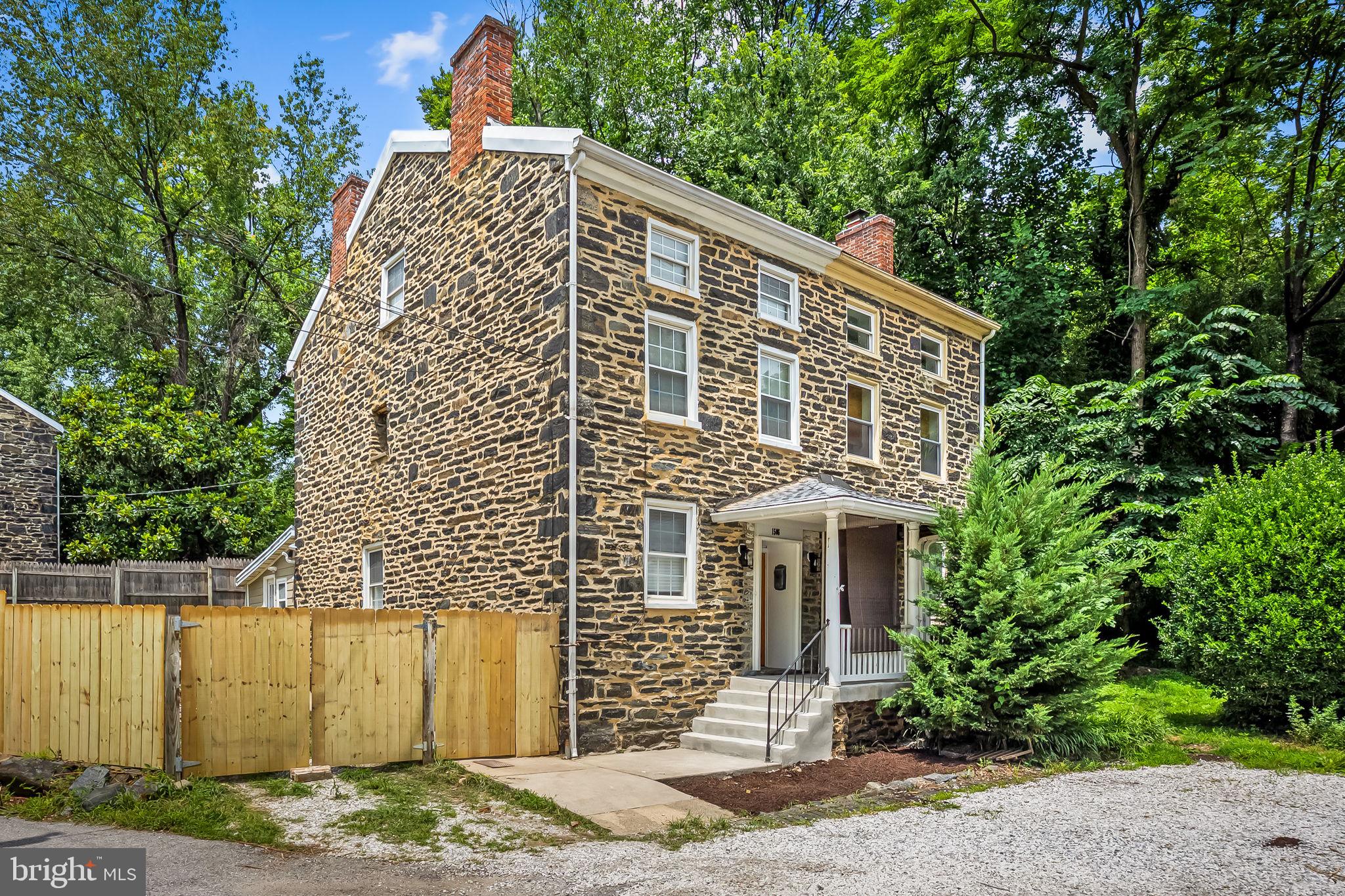 Welcome to this thoughtfully reimagined piece of Baltimore History in the heart of Historic Hampden! Originally constructed in the 1840s as foremen housing for the Whitehall Cotton Duck Mill which was responsible for the production of the famed clipper ships, this timeless property seamlessly blends historic charm with modern comfort in one of the rarely available three-story models. Original, refinished hardwood floors and authentic stonework are a testament to the care and craftsmanship that define this home. Boasting nearly 2,000 above grade square feet, this oversized 3 Bedroom / 2.5 Full Bath corner unit features exposed wood beams, recessed lighting, built-in electric fireplace, updated kitchen with quartz countertops and 3-seater waterfall peninsula, Italian ivory ceramic tiling, new stainless-steel appliances with smart refrigerator, and half bath on the main level with a dedicated utility and washroom to the rear. The second level offers front and rear well-appointed bedrooms with a renovated bathroom that includes the tub shower and tiled surround with built-in, floating vanity, casta diva toilet, anti-fog mirror, and gold hardware. The third level primary bedroom complete with ensuite bathroom and large walk-in closet also includes a stall shower with rainfall showerhead, freestanding soaking tub, and skylight with motorized shade. Additional updates include new 2.5-ton Ruud HVAC, new 40-gallon Rheem water heater, new architectural shingle roof, new 2-car gated parking driveway, new appliances. No expense has been spared! Situated just moments from local Hampden favorites, including the iconic "Avenue," the Clipper Mill Bike Path, and the scenic Jones Falls Trails, you’ll enjoy the perfect blend of urban lifestyle and outdoor adventure. Don’t miss your opportunity to own this one-of-a-kind, meticulously restored piece of Baltimore history!