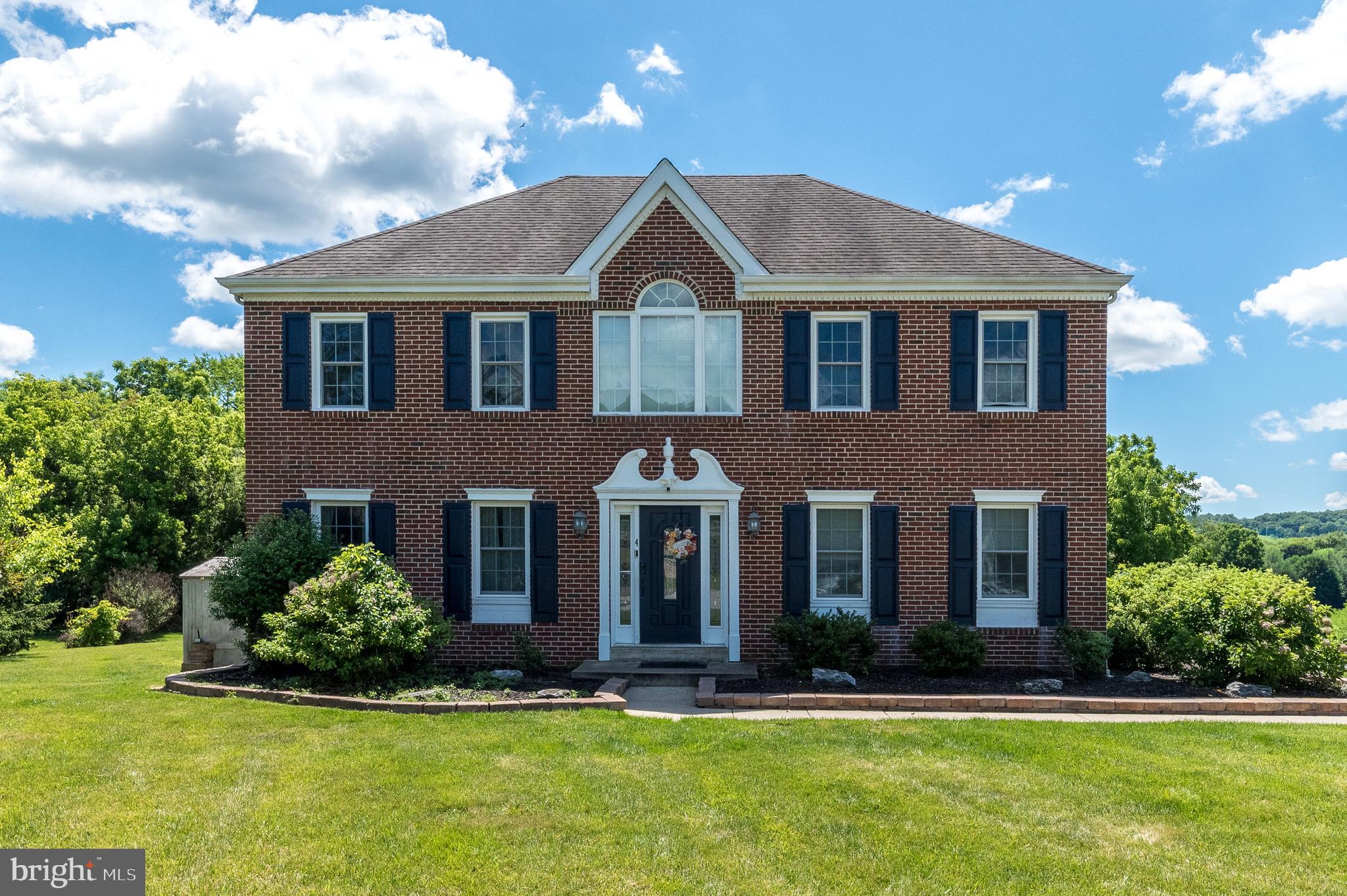Welcome to this beautiful brick front home featuring a large driveway, owned Solar panels (no lease), and lower electric bills. The front walkway is enhanced with pavers and surrounded by attractive garden areas, creating excellent curb appeal. Step through the center hall entrance, which leads directly to a spacious family room. The main level offers a formal dining room complete with wainscotting, chair rail molding, recessed lighting, and a ceiling fan. A large formal living room with double doors provides flexible space that can be used as a home office, playroom or additional gathering area.  The kitchen is truly the heart of the home and is loaded with desirable features, including hard surface countertops, white subway tile backsplash, an island with pendant lighting and seating, soft-close cabinetry, two glass front cabinets, and stainless appliances. Along the dining area wall, you will find built-in bench seating with convenient storage, adding both charm and functionality. The kitchen's dining area is filled with natural light from a skylight and features a coffee bar along with additional cabinets, providing plenty of storage and workspace. A well appointed powder room includes a tile floor and pedestal sink. Adjacent to the powder room is the laundry area, offering exceptional storage options throughout. This functional space includes abundant cabinetry and shelving, as well as utility sink, making everyday household tasks both convenient and organized. Step down into a welcoming family room featuring recessed lighting, a ceiling fan and direct access to both the rear and side yards. Adjacent is the in-law suite, offering a separate entrance, kitchen cabinets, a dining area, a bedroom and a full bath plus a walk-in closet.  Upstairs, the primary bedroom boasts carpet flooring, chair rail, ceiling fan, walk-in closet and an en-suite bathroom with shower. The hall bathroom offers a double vanity, tub with shower, and linen closet. Two additional bedrooms with ceiling fans complete the upper floor. The lower level has a recreation room, perfect for a man/woman cave. There is plenty of space in the finished area, even a little hideaway. The remainder of the basement is unfinished with plenty of room for your storage or you can finish into a gym, office, etc. Walk around the outside of the home. There is a patio off the kitchen and family room which leads to the gazebo with a slate patio. Great area for watching the young ones on the swing set, playing soccer, having a catch or just to seat and enjoy the weather. There is a large shed which is great for your yard tools. Several small storage units are located outside. The home has a fenced garden, private entrance into the in-law suite, a charging station for your electric vehicle and don't forget the solar panels.