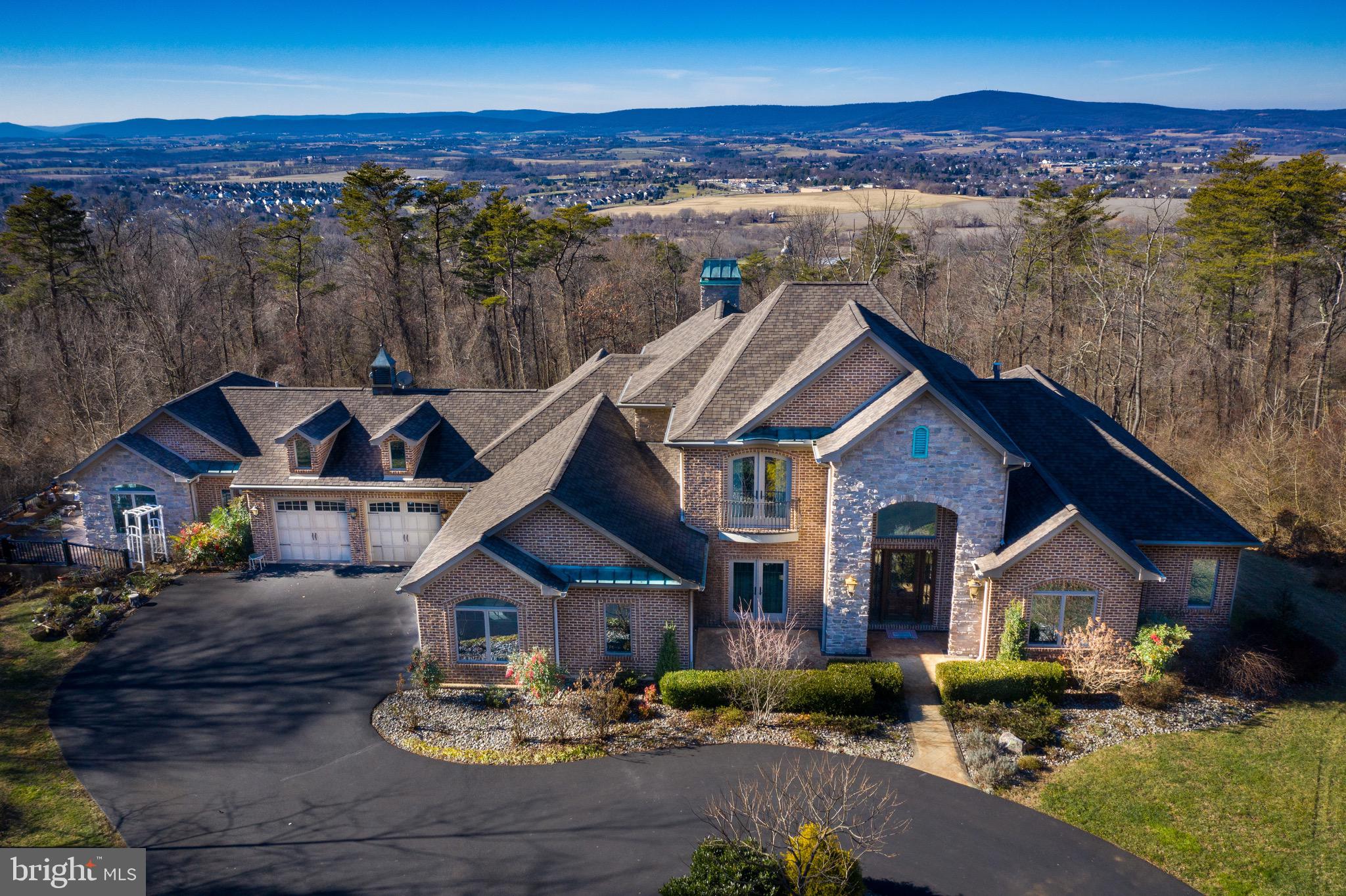 Once in a lifetime opportunity to own one of the finest properties in all of Frederick County. This one of a kind, well-built custom beauty situated on 7 private acres with amazing views overlooking Middletown Valley. Absolutely STUNNING with incredible attention to detail and superior craftsmanship. Excellent condition. Almost 10,000 sq. ft of luxury living. Features of the main home include custom granite kitchen with cream cabinetry, Thermador appliances, large center island, tiled backsplash, pasta arm, sunroom, formal living and dining rooms, main level office,  luxury family room with coffered ceiling, custom lighting, fireplace, bar and more.  Beautiful hardwood flooring, dramatic marble foyer wth curved staircase with wrought iron rails, pocket doors, custom moldings and features all throughout. Main level master suite with sitting room, private balcony, fireplace, amazing SPA bath with true steam shower, exquisite tile work, master closet with custom built-ins and more.  Upstairs features three large bedrooms with walk-in closets and two additional full baths. Large full walkout basement with soaring ceilings with built in vault/ bank-rated safe. This property also includes a full in-law apartment with second kitchen, second living room, second laundry room, bedroom with walk-in closet, private deck and garage.  Outdoor features multiple balconies, patios and decks.  Large circular driveway and 4 Car oversized garage.  Conveniently located near major commuter routes, shopping and restaurants. Middletown Schools!