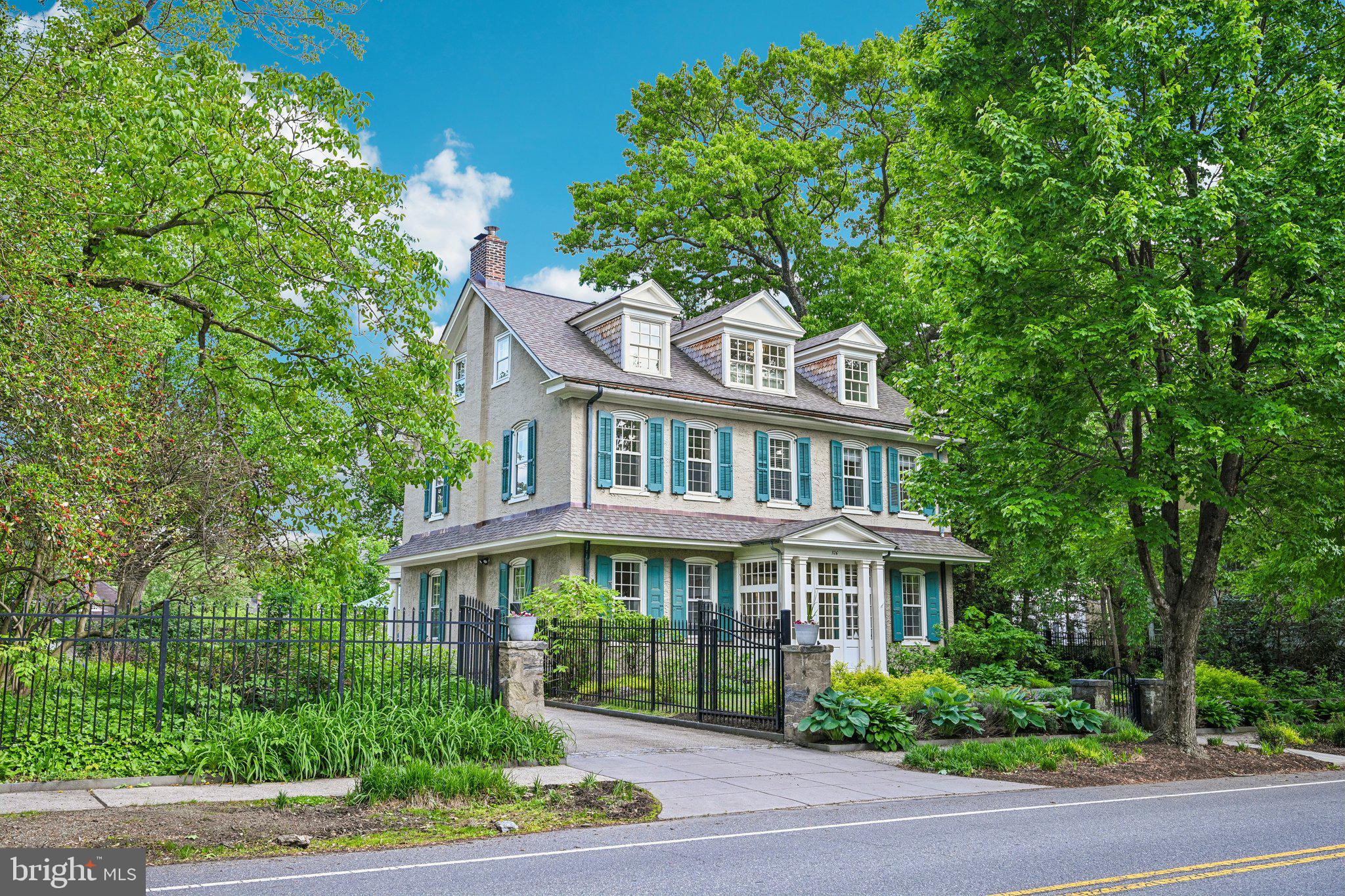 Nestled on over an acre of beautifully landscaped, flat grounds in coveted West Mt. Airy, this extraordinary property offers timeless character, exceptional space, and meticulous care throughout. Surrounded by mature oak, walnut, cherry, apple, and dogwood trees, the setting is both private and picturesque — a true oasis in the city. Enter inside to a bright foyer adorned with gorgeous original heart of pine wood floors that continue throughout the home. The foyer is flanked by a formal living room featuring a fireplace and elegant French doors leading to the patio, as well as a cozy sitting room ideal for a home office. The sitting room conveniently connects to the laundry room and powder room. Further inside, the expansive formal dining room impresses with oversized windows and a stunning decorative fireplace centerpiece, creating the perfect setting for entertaining. At the heart of the home is the spectacular eat-in kitchen, thoughtfully designed for both everyday living and gatherings alike. Highlights include an oversized center island with seating, white shaker cabinetry, newer stainless steel appliances, a built-in buffet counter with a second sink, space for casual dining, and a gas fireplace. Sliding glass doors open seamlessly to the oversized bluestone patio, blending indoor and outdoor living. The second floor offers exceptional flexibility and comfort with two bedrooms connected by a full bathroom, while one of those bedrooms also enjoys access to an additional full bath with hallway entry. Two more spacious bedrooms, another full hall bathroom, and a versatile flex space perfect for a home office, playroom, or sitting area complete this level. The third floor features two generously sized bedrooms sharing a full hall bathroom, offering ideal accommodations for guests, family, or additional workspace. Outside, the property truly shines. The stunning outdoor retreat is filled with mature perennial gardens and centers around a beautiful oversized pool with a bluestone surround and pergola-covered deck for relaxation. Adjacent to the pool is the charming standalone 1900 carriage house, complete with a bathroom, garage, and workshop space — which could make a perfect pool house, studio, or creative space. Beyond the garage, an established organic vegetable garden has thrived for more than 19 years. Extensive recent improvements provide peace of mind, including full reroofing, SIKA stucco coating, replacement and upgrade of eight large windows from Pella standard to custom, upgraded electrical service with removal of all knob-and-tube wiring, new air-source heat pumps and air handlers, a high efficiency Buderus boiler back up system that provides heat on the coldest day, redesigned front landscaping, replaced sidewalks and front walkways, and the addition of a PHS-designed rain garden. Ideally located just two blocks from the Allen's Lane train station and multiple direct access points to Wissahickon Park, this remarkable home also enjoys close proximity to Germantown Avenue’s restaurants, Quintessence Theatre, Coop Grocery, and several local schools. A rare opportunity to own a truly special property in one of Philadelphia’s most sought-after neighborhoods. Mortgage savings may be available for buyers of this listing.