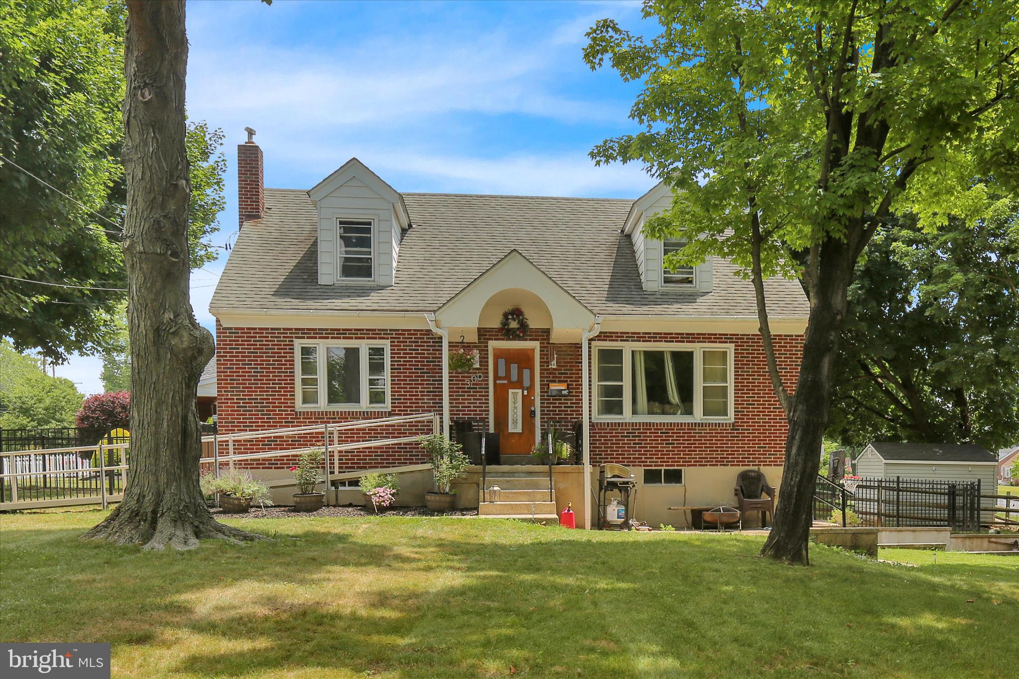 This charming brick Cape Cod offers a classic silhouette and a functional layout on a spacious corner lot. The main level welcomes you into a comfortable living room that leads to an inviting eat-in kitchen, perfect for casual dining and morning coffee. Two of the home’s four bedrooms are conveniently located on the first floor alongside the full bathroom, providing easy one floor living options, while the additional two bedrooms are tucked away on the second floor for added privacy.
The lower level features a full, unfinished walk-out basement that presents incredible potential for customization or storage. Natural light pours into this space through sliding glass doors that lead directly to the exterior. The basement is divided into two distinct rooms, including a dedicated utility room equipped with a gas heater, central air system,  water heater, double bowl utility sink, and laundry area.
Situated on a prime corner property, the home is surrounded by both a front and rear yard, providing ample outdoor space for gardening or recreation. The property is also equipped with a handicap ramp for improved accessibility for the future buyer!  Professional Photos Coming Soon!