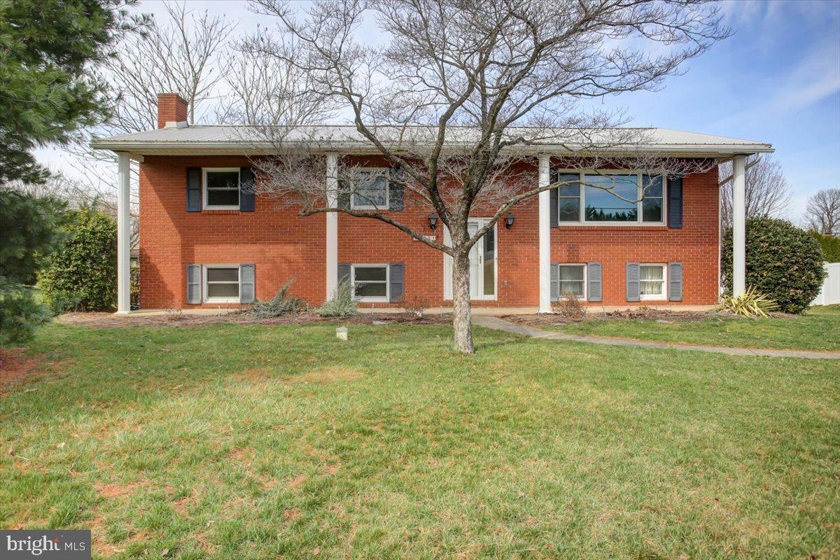 Welcome to 9031 Molly Pitcher Highway, just minutes from downtown Greencastle. This sturdy bi-level home offers a peaceful retreat off the main road, featuring a solid concrete foundation and a spacious front yard. A long, straight driveway leads to a hidden garage and ample parking space. The expansive asphalt area creates a versatile outdoor space, perfect for games, gatherings, and enjoying the fresh air. The oversized deck features a covered dining area, offering additional room for entertainment and relaxation.

Inside, the garage includes a large workshop area, ideal for hobbies and storage. A separate room, with new flooring and fresh paint, offers flexibility and could serve as an office or additional bedroom. The lower level features a cozy family room with a wood-burning fireplace, enhanced by new ceiling tiles and freshly installed carpet.

Upstairs, the main living area welcomes you with a bright and airy living room that flows seamlessly into the combined dining area and kitchen. All three bedrooms boast professionally cleaned hardwood floors, and the primary bedroom includes a private half-bath. 

This well-maintained home is ready for its next chapter! Updates include newer windows, fresh paint, new carpet throughout, new toilets, a few new light fixtures, and a recently installed water heater (2024). Come see this conveniently located home and add your personal touches.