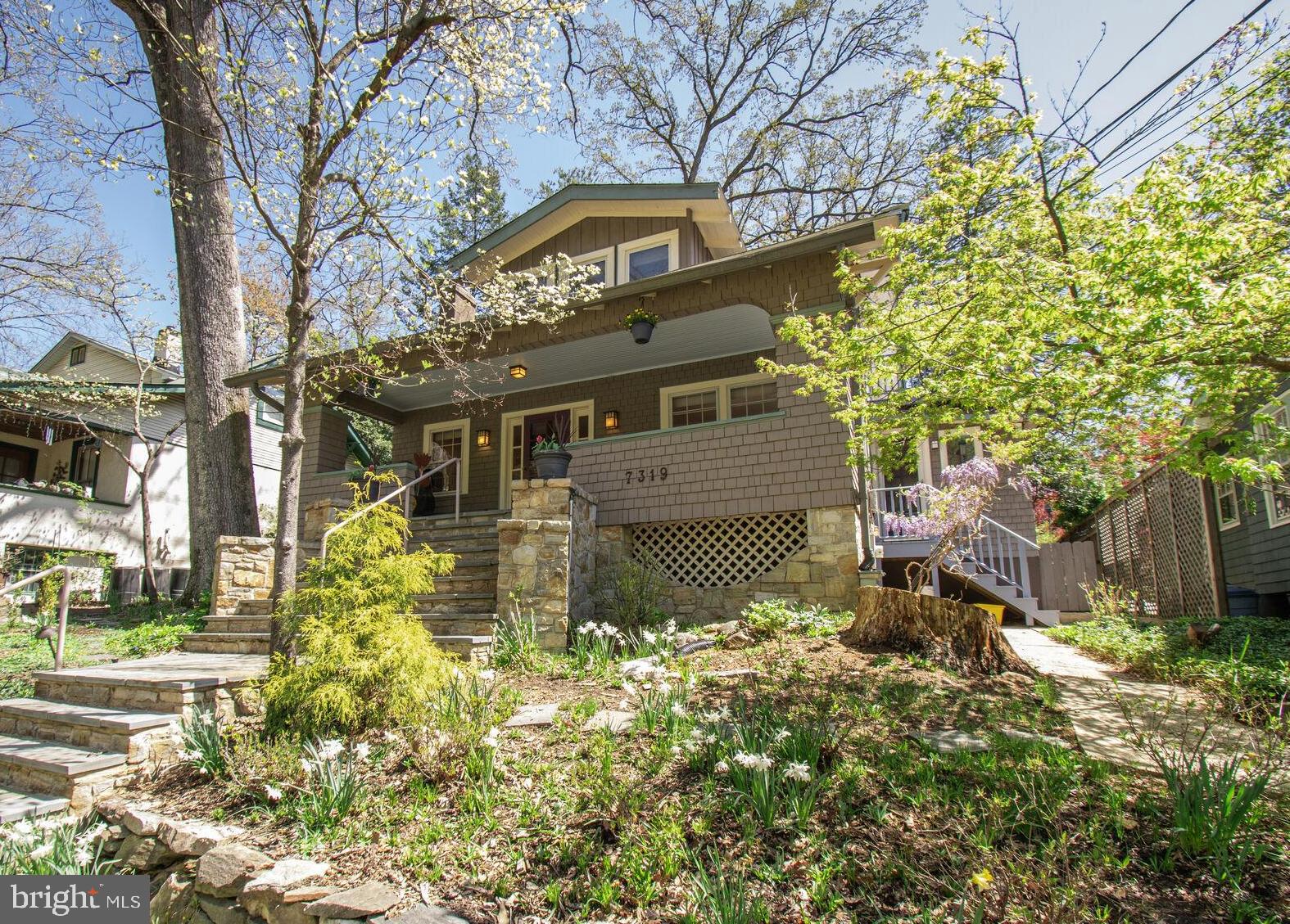 Stunning Bungalow in pristine condition on one of Takoma Park's premier streets, is just blocks to Old Town shops, restaurants, Farmers Market, and about 1/2 mile to Metro.  The original architects of Willow Avenue aimed to feature every variation of the vernacular Arts & Crafts style on this one street: examples include Prairie style, Chalet style, Tudor Revival, Foursquare, Shingle Style and  the classic Bungalow.  7319 seemlessly blends  the best of the original bungalow shingle charm with all the modern conveniences. This is the one you've been waiting for! Perched on a hill overlooking the  Historic street, with lovely stone and slate hardscape and  classic mature landscaping, this house will steal your heart.  Enter from the charming front porch into a modern open floorplan  living, dining, and kitchen areas.  The living area features a cozy brick fireplace (wood-burning) surrounded by bulit-in shelves and side light windows.  Natural wood trim on the doors and windows creates a stylish and warm feel.  Hunter Douglas custom shades throughout.  The hardwood floors are especially lovely and in beautiful condition.  There is a large arch leading from the dining area to the kitchen.  The sleek and bright kitchen features ceramic tile floors, a beverage bar with built in wine glass storage, granite counters and GE Profile french door fridge and dishwasher, and a Cafe 6-burner gas stove with microwave.  Stylish pendants over the sink area and breakfast bar plus recessed lighting brighten the space.   A glass door leads to the side entry through which you can glimpse the blooming wisteria. A beautiful tudor-style pass through window with natural molding to echo the rest leads from the kitchen into the family room behind.   This space is perfect for reading, TV viewing and all family activities, and it leads to a glorious skylit sunroom  at the rear.  From the sunroom you have a view of the sweet back garden which features perennial beds, magnolia and redbud trees, an espalier pear tree, and an apricot tree.  The sunroom opens to a large multi-leveled deck with built-in corner bench with storage,  perfect for relaxing and outdoor entertaining.  Pizza lovers! Let me introduce your very own stone pizza oven in the yard!  Featuring a beautiful catenary arch design, amd mosaic tile details, it will be the centerpiece of your parties! We will provide tips on the usage as needed!  Parking for 2 vehicles beyond the garden  with access from the alley, and a shed for garden tools.  A gorgeous renovated full bath with beautiful leaf patterned ceramic tile floors  and a tub/shower combo with frameless glass doors completes this level.

Upstairs, be prepared to be wowed by a dramatic central landing with vaulted ceiling and a porthole window, surrounded by four  bedrooms, each with it's own special charm.  A very large and beautifully updated hall bathroom, and a walk in closet are also accessed from this landing.   The primary bedroom features recent hardwood maple flooring, lovely views of the rear, and a decorative stained glass window.  Bedroom #2 features a built in storage bench/window seat.  Bedroom #3 has great views and  a wonderful large closet with under eave storage. Bedroom #4, also with a large closet, opens to an upper level deck.  
The lower level has a semi-finished flex room with mini split for AC and exterior walk out door. 
 Currently used as an exercise room , it could be an office, playroom or bedroom with ensuite vintage bath.  There is plenty of storage in the utility area, with recent front loading Maytag washer and dryer and a workbench.  
Enjoy all the many pleasures that Takoma Park living has to offer,  in the unique style that is 7319 Willow Ave!