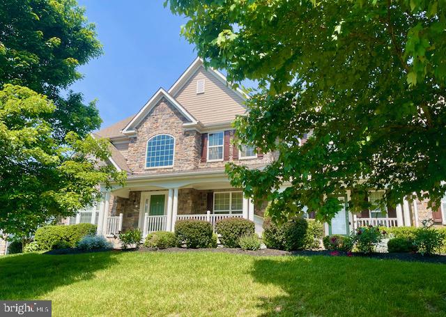 Stunning Colonial Home nestled in Evergreen Hamlets along the prestigious Evergreen Reserve of Ashburn / Broadlands, expertly crafted by K. Hovanian. This luxurious 5-bedroom, 4.5-bathroom Stone-front home greets you  with an exquisite design and meticulous attention to detail, it exudes elegance and sophistication.  Seated on 1.22 acres that back the woods for lovers of nature.  This home boast of over 6000 sqft of living space. From the moment you step through the inviting front covered porch, the spacious entry welcomes you into the heart of the home, adorned with gleaming hardwood floors and custom molding.  As you enter inside the two-story wood floor foyer, you'll be greeted by an elegant formal living room and a stately formal dining room.  The family room, featuring a light and bright living space with floor to ceiling windows, a cozy fireplace, the living room that seamlessly connected to the kitchen, creating an expansive and open space for both relaxation and entertaining. The gourmet kitchen is chef's dream, and feature  stainless steel appliances,, sleek granite countertops, premium cabinetry, top cabinets with under light that brings uniqueness, and a center island perfect for culinary enthusiasts. It boasts full-sized double ovens, a built-in microwave, ample pantry, cabinet storage, and a spacious eat-in area filled with natural light.  Additionally, a bright and versatile sunroom off the kitchen adds an extra touch of charm and comfort to this home. The sunroom leads to a covered porch with steps that takes you down to an outdoor living paver patio, with stone grille, perfect for relaxing, entertaining, or unwinding.  On this level, you will also find a pantry, and laundry room with access to the garage. Also, an offices, perfect for your work-from-home needs. Upstairs, the primary suite is a luxurious retreat,  with   custom walk-in closets and a spa en-suite bathroom.  it also offers an extra sitting area, providing a private retreat within the home. Three additional generously sized bedrooms, one with its own bath, and two bedrooms sharing a Jack and Jill bath,  provide ample space for family or guests. The lower level of this home is designed for entertainment, with full bar, a recreation room and also featuring a spacious bedroom en-suite with cozy fire place and abundant closet space. An outside entrance leads to the back yard with paver patio with fire place to enjoy the outdoors and provides an excellent space for gatherings.