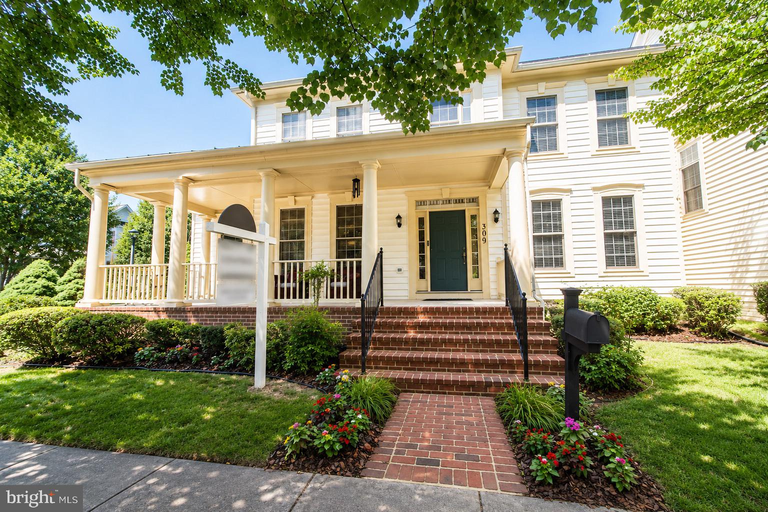 Nestled on a prominent corner lot in the coveted Watkins Pond section of King Farm, this elegant country-inspired residence blends timeless architecture, sophisticated entertaining spaces, and the convenience today’s buyers are searching for. Framed by a gracious covered porch with Tuscan columns, lush landscaping, and a charming stone and slate patio, the home offers warmth, privacy, and an elevated lifestyle from the moment you arrive.

Step through the front door into a grand two-story foyer with soaring ceilings, a sweeping staircase, and sun-drenched interiors that feel both airy and inviting. Gleaming hardwood floors span the main level, while custom trim work and architectural columns add richness and refinement throughout. The formal living and dining rooms were thoughtfully designed for memorable gatherings, intimate dinners, and elegant entertaining. Filled with warmth and history, these spaces have welcomed conversations that stretched from family celebrations to global affairs, creating a home layered with meaning, connection, and legacy.

At the heart of the home, the gourmet kitchen is designed for the way buyers live today; open, functional, and perfect for gathering. Featuring updated appliances, an expansive center island with seating, sunny breakfast area, command desk, and abundant cabinetry, it effortlessly balances beauty and practicality. The kitchen flows seamlessly into the dramatic two-story family room with Palladian windows and a cozy gas fireplace, creating the ideal backdrop for everyday living, entertaining, or quiet evenings at home.

The outdoor spaces feel like a private retreat. Just steps from scenic walking trails and tranquil Watkins Pond, the backyard invites peaceful morning coffee, devotional time, alfresco dining, or sunset toasts surrounded by nature.

The flexible floor plan offers the versatility modern buyers crave, including a sought-after main-level primary suite complete with oversized walk-in closets and a spa-inspired bath. Upstairs, you’ll find a spacious ensuite bedroom with its own walk-in closet, two additional oversized bedrooms, and a versatile loft/library space ideal for a second office, study lounge, media area, or reading retreat.

The fully finished lower level expands the home’s functionality even further with two guest rooms, a large recreation room, cedar closet, bar area, storage, and abundant space for entertaining, multigenerational living, fitness, hobbies, or extended stays.

Thoughtfully maintained and updated, the home features a newer roof replaced in 2020, energy-conserving solar panels for enhanced efficiency and long-term savings, dual HVAC systems, newer water heater, and sump pump, offering comfort and peace of mind for years to come.

Located in one of Rockville’s most beloved and walkable communities, residents enjoy access to pools, parks, trails, shops, restaurants, grocery stores, postal services, and a neighborhood shuttle to Shady Grove Metro. With quick access to I-270, ICC-200, I-495 commuting to Bethesda, Washington, D.C., Northern Virginia, and major airports is remarkably convenient.

This is more than a home, it is a lifestyle of elegance, comfort, community, and connection.