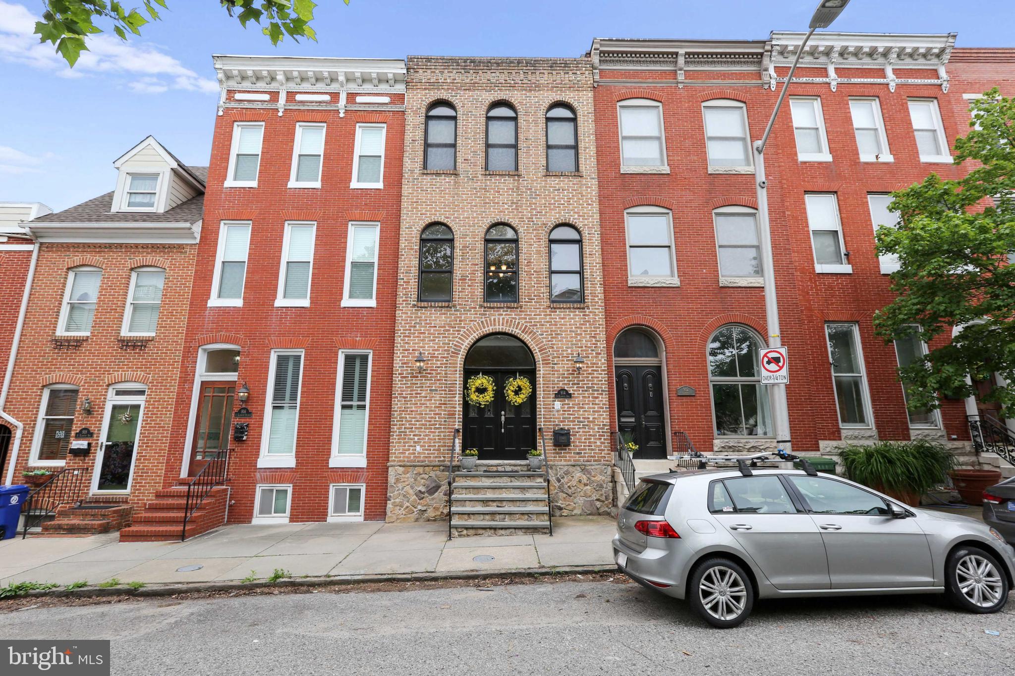 Welcome to 914 S. Ellwood Ave, where Baltimore City meets European Architecture. This upscale home has it all, with rod iron rails, floating stairs, coffered ceilings, federal style wainscoting, solid oak floors throughout and much more! Through the front door you are greeted by 20 foot high ceilings with Richardson Romanesque windows and stone accent walls. The three windows on the front of the home give the interior a ton of natural light. The living room flows openly into the kitchen that is followed by a dining room. The elegant sconce fixtures and wainscoting through the dining area really give a fine dining experience to the home. Take a breath of fresh air; on the back of the home there is a patio that is draped with beautiful vines and plants and a custom brick patio. The second level has two full bedrooms, an office, and a full bathroom. The bedroom on the second level towards the front of the home has a juliet balcony that gives upscale living its definition.  Up the grand oak staircase to the third level youâll find the owner's suite. This level has a very large bedroom with a grand walk-through closet that âJack and Jillsâ to the main hallway. Keep in mind that the entire home has custom wainscoting, crown molding, and beautiful meticulously kept solid oak floors that flow throughout. The owners bathroom has a large glass shower and a jacuzzi tub with a double sink vanity and custom shelving. On the back of the owners suite you will find a spare room that can be used for entertaining, working out, or as an office, with a wet bar that leads to the two tier deck. Find one of the most beautiful views youâll ever see in your life on the rooftop of 914 S. Ellwood Ave. You can see the entire water scene of the inner harbor and a vest complete and unobstructed view of the Baltimore city skyline. Let's not forget about the fully finished basement with a full bathroom and a separate closed off room for a large walk in storage and utility area. Additionally, this home is located within a five minute drive to the Safeway 24/7 grocery store, a six minute drive away from the Target/Harris Teeter shopping center, and a ten minute walk to Canton Square.  This one wonât last long!