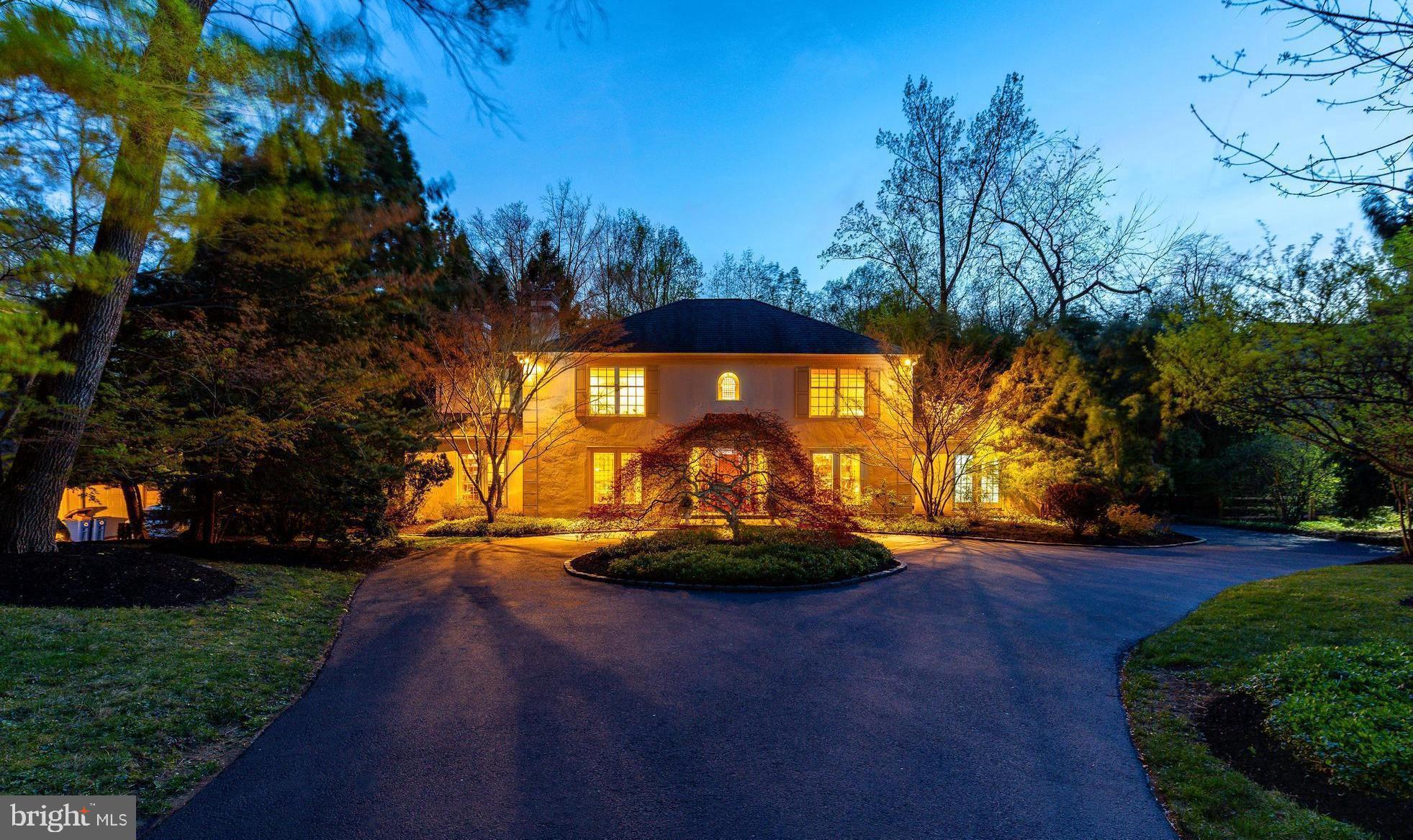 Tucked within an exclusive double cul-de-sac in the heart of North Bryn Mawr, this French Provincial Style Center Hall Colonial is a rare offering in highly desirable Lower Merion Township. Set on 0.97 acres of beautifully landscaped grounds with a gunite pool and spa, the home offers 4 bedrooms, 2 full bathrooms, 2 half bathrooms, a home office, and 5,098 square feet of exquisitely finished living space. Defined by its symmetrical façade, steep hip roof, arched dormer window, and refined architectural detail, this residence blends timeless Main Line tradition with European elegance and nearly 50 years of devoted single ownership.
A circular driveway leads to a gracious front entry framed by mature trees and lush plantings. Inside, you’re welcomed into a dramatic marble foyer, flanked by formal living and dining rooms, both adorned with herringbone hardwood flooring imported from Thailand. The living room features a wood-burning fireplace and opens directly to a handsome home office/study with built-in bookshelves—perfect for working from home or enjoying a quiet retreat. The dining room comfortably seats fourteen—ideal for elegant dinners or holiday gatherings.
At the heart of the home is the Joanne Hudson-designed kitchen, showcasing custom cream-colored cabinetry, limestone tile flooring, and a handcrafted limestone-paneled hood and backsplash. Marble countertops and a large, furniture-style island with carved detailing and built-in bookshelves enhance the space. A farmhouse sink framed by an oversized bay window offers serene garden views. High-end appliances include a Wolf 6-burner gas cooktop, SubZero refrigerator, double wall ovens (2021), two Miele dishwashers (1 was replaced in 2025) , and a built-in SubZero wine fridge. Custom William Ohs built-ins add both function and beauty. The kitchen opens to a bump-out breakfast area with vaulted ceilings, expansive windows, and French doors leading to the backyard oasis.
Outdoors, the flat, usable backyard is an entertainer’s dream, featuring a flagstone patio, extensive hardscaping, an irrigation system, and a gunite pool and spa surrounded by manicured landscaping.
Adjacent to the kitchen, the family room features exposed wood ceiling beams, a green-tiled wood-burning fireplace, and hand-laid terracotta Mexican tile flooring with decorative insets. This inviting space flows into an attached sunroom with floor-to-ceiling windows, custom painted art-deco-style trim, and French doors opening to the backyard, perfect for year-round relaxation. The seamless flow between formal and informal spaces, indoors and out, creates an ideal layout for both intimate gatherings and large-scale entertaining.
Upstairs, the primary suite offers a sunny sitting room, plush carpeting, and three walk-in closets. The luxurious spa-style bathroom includes a deep, built-in soaking tub beneath a wide window, detailed tilework with marble trim, an oversized dual vanity with classic brass sconces, and a glass-enclosed, stone-tiled shower with multiple shower heads and body jets. Three additional bedrooms—two with hardwood floors—share a skylit hall bath with dual sinks.
The fully finished lower level provides versatile living space with new carpet, fresh paint, and a powder room, suitable for a home gym, media room, or play area.  Additional upgrades include: New Furnace (2025), First Floor HVAC  (2025),  Second Floor HVAC - New Blower (2025), Leaf Filter (2024).
Located in the award-winning Lower Merion School District, this exceptional home offers privacy, elegance, and enduring character, with convenient access to Bryn Mawr town center, King of Prussia, and major commuting routes.