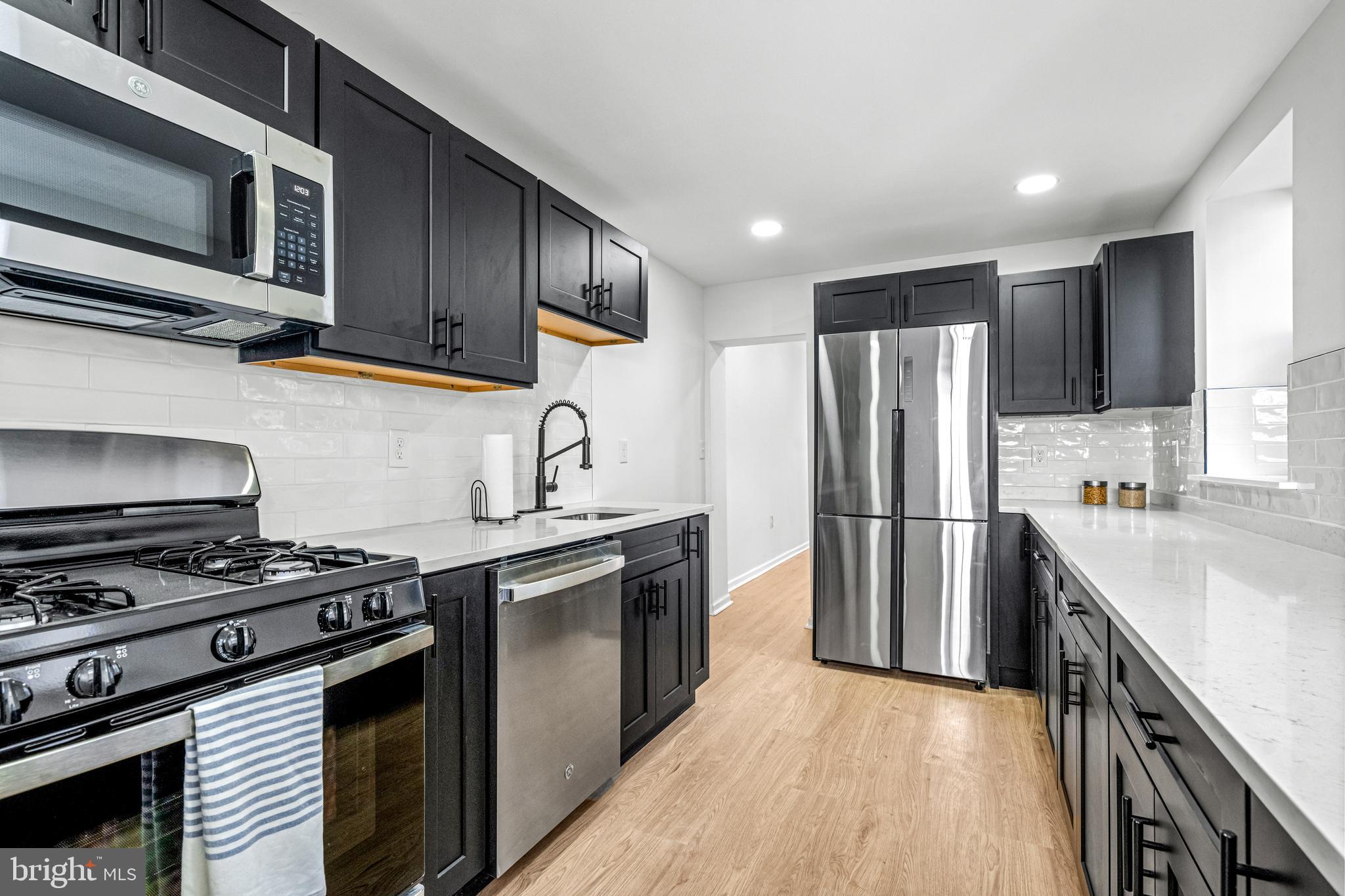 Welcome to this beautifully renovated row home in the heart of Fishtown!  As you step inside, you'll be greeted by brand new wide plank flooring, freshly painted walls, modern accents, and a spacious layout. The newly added half bath boasts geometric tile flooring, a modern wood vanity, a statement mirror, and timeless hardware. The expansive kitchen features sleek custom cabinetry, a stylish tile backsplash, brand-new appliances, and ample counter space perfect for any aspiring chef. From the kitchen, you can access the back patio. Upstairs, you'll find three bedrooms and a full bath. The bedrooms offer the same wide plank flooring, large windows, modern lighting, and generous closet space. The full hall bath includes a tile stall shower, a fresh vanity, tile flooring, and a sizable window. The primary bedroom offers spaciousness, high ceilings, and plenty of storage options. The unfinished basement provides additional storage space and convenient laundry access. Situated on Gaul Street, this home is nestled in the vibrant Fishtown neighborhood. You'll have easy access to popular restaurants and public transportation makes this an incredibly desirable location. Don't miss out on the opportunity to add this newly renovated gem to your must-see list!