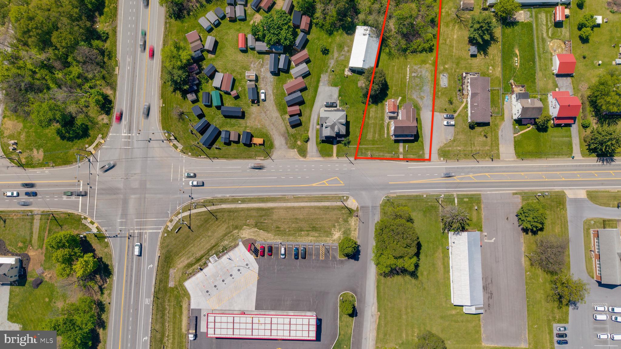 The Land Other Developers Overlook — Until It's Gone
In commercial real estate, position is everything. This  0.84-acre Business General (BG) zoned parcel at the intersection of National Pike (Rt. 40) and Greencastle Pike (Rt. 63) isn't just well-located — it occupies one of the most strategically significant positions in Washington County's western corridor.

The numbers tell part of the story: Interstate 70 is 1.8 miles away. Interstate 81 is 2.8 miles out. Greencastle Pike feeds directly into I-70's diamond interchange at Huyett, making this corner a natural funnel for regional traffic moving in every direction. National Pike carries the kind of daily volume that commercial tenants and highway-facing businesses build their entire site-selection criteria around.

But here's what the numbers don't capture. This parcel sits directly across from the entrance driveway of Sheetz — one of the region's most consistently trafficked fuel and convenience destinations. In Maryland highway permitting, that alignment matters. The State Highway Administration typically requires new access points to align with existing driveway cuts on the opposite side of the road. That cut already exists. It's across the street. This property is the other half of that equation.

The existing structure — a converted 3-unit residential building — offers a holding income opportunity while entitlement and development plans are advanced. The building does not define the value here. The land does.

For the right buyer, this is not simply an acquisition — it's a completion. Whether the end use is fuel, food service, retail, or a broader mixed-use development, the infrastructure, zoning, and traffic count are already working in your favor.

Opportunities like this don't stay quiet long. 
Call today to discuss the full picture!