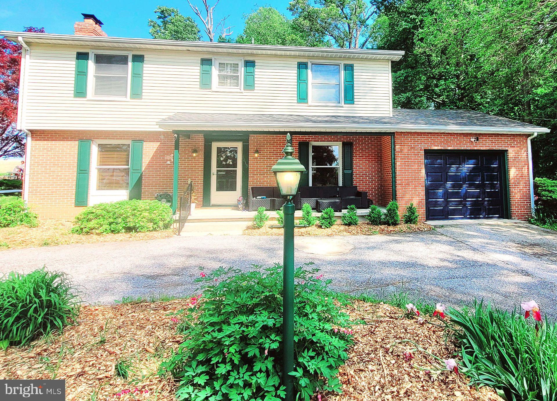 Welcome to 1815 Manchester Rd, a quiet place to call home.  This home qualifies for USDA Financing.  Buy with 0% down payment for qualified buyers. This solid 4BR, 3.5 BA colonial with one car garage is situated on a .55 acre lot.  Inside you'll be greeted by a center staircase.  Prepare and serve delicious meals in the open spacious kitchen and dining room. The kitchen features stainless steel appliances, updated cabinets, quartz countertops and a generous island for family gatherings.  The family room offers a cozy wood burning fireplace to enjoy cooler nights and easy access to the full bath with walk-in shower. Get laundry done without all the stairs with the convenient main level laundry room which has a rough-in for a hall bath.  On the upper level you will find beautiful gleaming hardwood floors and 4 spacious bedrooms with abundant closets and full bath. The owner's suite includes an updated private full bath with walk-in shower.  Design and create your own space in the unfinished basement which includes a half bath.  Got allergies - no problem, no carpet here. The backyard features 2 gazebos, a playset and storage shed.  Enjoy riding trails and plenty of space for outdoor summer fun and gardening. Improvements include roof 2015, water heater 2018, well pressure tank 2019, heat pump 2016, well 2016, kitchen updated 2021. The garage has been recently insulated, drywalled and new insulated garage door with remote. The exterior has been freshly painted and refreshed landscaping offers great curb appeal. The circular driveway provides additional parking for guests.  This home offers the perfect balance of rural living just a short distance from all the conveniences you need.