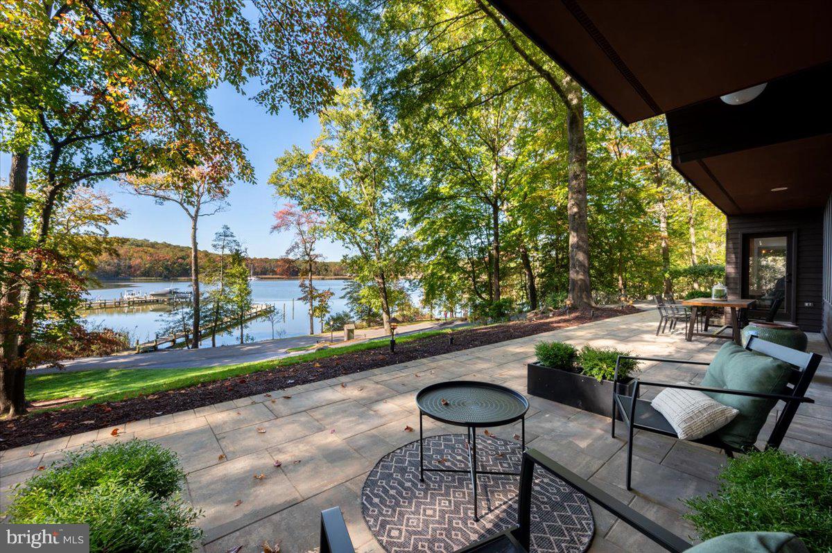Experience luxury waterfront living in this stunning contemporary home, featuring expansive water views from every room.  Enjoy an open floor plan for all of your hosting and entertaining needs.  The home is bathed in natural light, thanks to floor-to-ceiling windows that seamlessly blend indoor and outdoor spaces.  Step outside to the massive paver patio perfect for entertaining or enjoying the water views.  With western exposure, there are gorgeous sunsets every evening.  It's the perfect time of year to cozy up to the new masonry, wood burning fireplace with stone facade in the living room!  Everyone in the family can have the "best" room since all four bedrooms have a water view.  Retreat to your primary suite with private deck overlooking the water and completely remodeled ensuite bath including stand alone soaker tub, walk-in shower and two sinks.  Bedroom 2 also has a completely remodeled ensuite bath.  Head to your private pier for an evening cruise on the Severn River or for a fun-filled day, venture out to the Chesapeake.  You must see this home to truly appreciate its beauty!
There have been so many thoughtful and timeless renovations executed on this home in the past year, including: 
Entire 2nd level has new hardwood floors, solid wood doors and closet doors, new baseboards and casings. 
New LED lighting and recessed lighting added on 2nd floor
New electric black-out shades in the primary bedroom
All new interior paint
Refinished floors on the main level
All new ceiling fans
Complete new sod installed