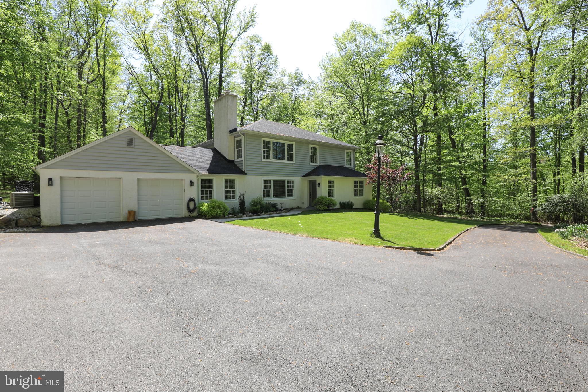 Private drive - please do not drive down driveway without an appointment.  Beautiful in Buckingham, 5+ acres, 5 years old down a stunning tree-lined driveway to your own private Central Bucks East oasis that is pure paradise!  Prior owner took this back to the foundation and completely redid the entire home so there was nothing left from the old structure but the foundation. In addition, the current seller put in a 40’ custom salt water pool surrounded by a 2-tier patio with fire pit, sitting wall, indirect lighting and extensive landscaping, giving you complete privacy but you are so close to everything Central Bucks!  Then when bad weather strikes, you’ll have a whole house generator!  Seller also put in a water purification system, a detached custom 2 car garage with electric and heat and car lift that, did we mention stays?!  Hello car enthusiast!  There are security cameras front and rear and the home is as clean as you could ever imagine, 2 full baths never used and a fully finished basement that is currently a high-school haven including a full bath.  It’s ideal for that and would also make an excellent gym, office, theatre room or play area, craft room, anything you need!  Hardwood floors gleam throughout the home, the open floor plan is warmly inviting and the photos say it all.  The first floor bedrooms with a stunning never-used bath in between are currently being used as his/her office. The views from every window remind you of your private setting to hear nature year round and enjoy to its fullest.  The very large spacious dining room is great for all gatherings and holidays, with tall ceilings and flexible use of space all convenient to the kitchen. The back hall with storage closet opens to the 2 car attached garage with extra front storage area.  Upstairs you’ll find a lovely 3rd bedroom with a gorgeous large unused bath in the hallway, two sinks and a tub shower with beautiful accents.  The upstairs laundry space is adjacent in the hall closet, and off the inviting hallway you’ll find the beautiful large main bedroom.  The views welcoming in all the tree beauty and the main bath bath is so luxurious!  2 sinks, large soaking tub, exquisite large shower with seamless doors, private commode room and nothing but squirrels, birds and trees to look at!  Walk in his/her closets with built ins complete this main retreat.  Outside is serene beauty, quiet, inviting and enjoyable for year round pleasure.  Truly a new paradise in a fantastic setting so you feel like you are far removed, yet you are minutes from everything from schools to shopping, fine dining, parks and more.  This is a rare opportunity!  Seller needs an end of June closing.  RR Tracks adjacent to the property are exclusively for the iconic Bucks County New Hope visitor steam train that residents have a county-wide affection for as part of the attraction to the quaint nuance of the County.  It's a rare occurrence and delightfully whimsical!