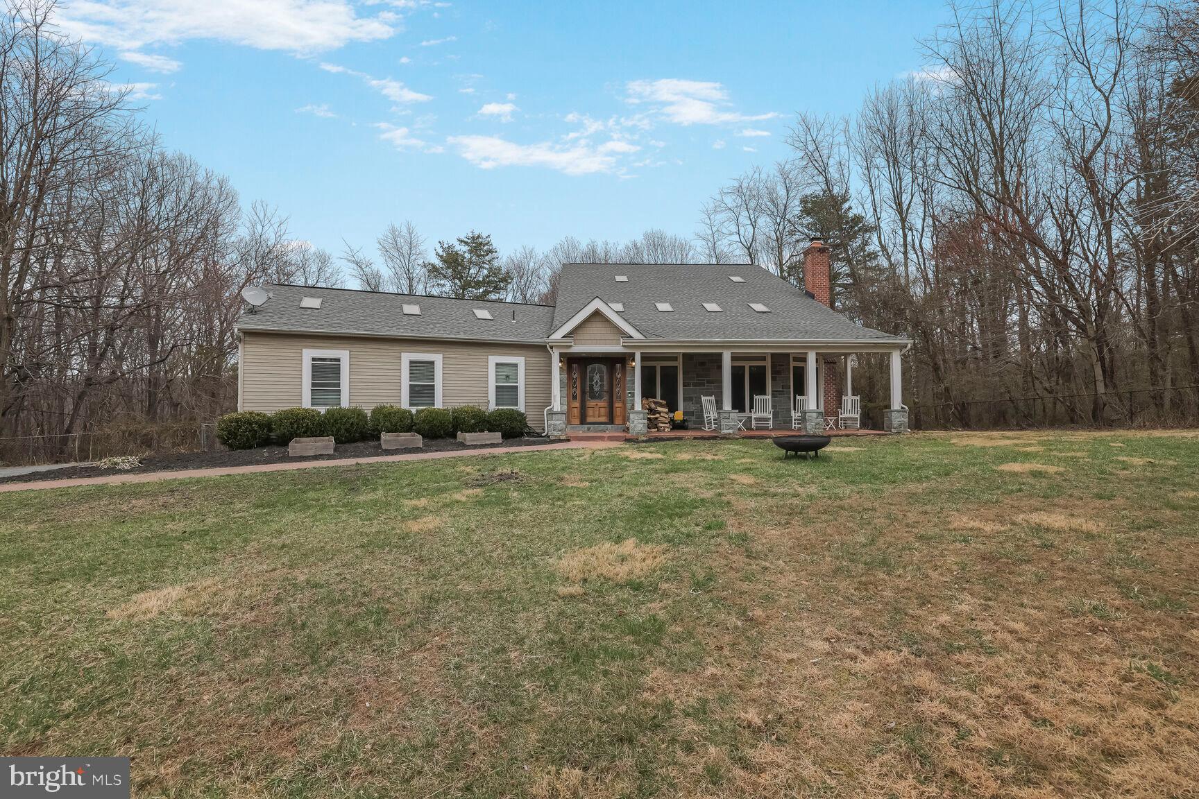 PRICE DROP! VERY MOTIVATED SELLER. Welcome home to this remarkable property! It is nestled on just under nine acres and includes a private driveway, a cozy front porch, and a huge detached 2-car garage. The main area of this home is open and airy, with skylights, recessed lighting, and high ceilings. There is a living room with a fireplace, a dining area, and a modern kitchen. There is even a first-level in-law room with an en-suite bathroom. The primary bedroom is spacious and features a large walk-in closet and a private bathroom with a shower and separate tub. This home has it all! Schedule your showing today before it’s too late!