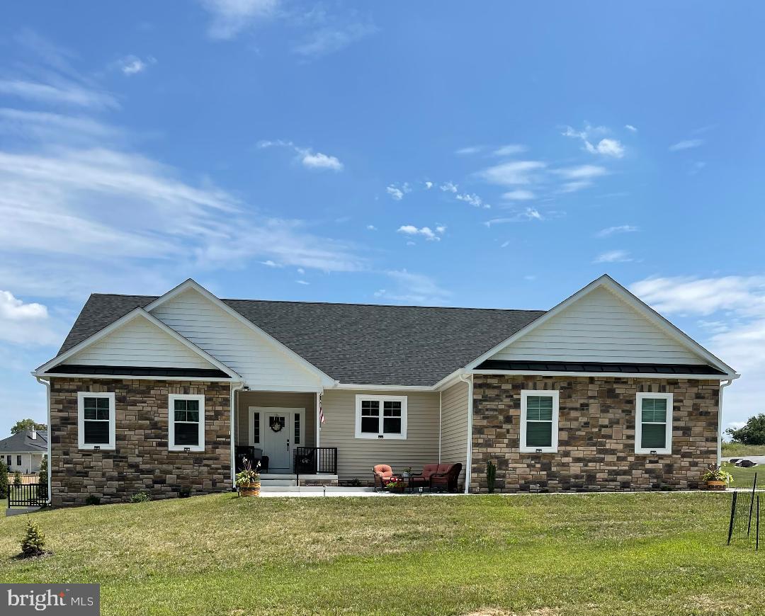 PRICE CORRECTION! FURTHER REDUCED AND MOVE IN READY! With building completed in 2022, this almost new custom built rancher is move in ready!  It is set on a nice corner lot in the beautiful Brookside neighborhood on the west side of Martinsburg, and it has all the most desirable features - open spaces with high ceilings, natural lighting and modern finishes, side load garage and an expansive unfinished basement, and a split bedroom floorplan for added privacy.  The home is centered around a large living area with family room, dining room, and kitchen, all with easy access to the fenced patio area and back yard.  The kitchen is outfitted with stainless steel appliances, full height cabinets, and a large island with counter-height seating.  There are 4 large bedrooms all on the main floor, a large unfinished basement to expand into, plus a great outdoor area for entertainment and outdoor dining.  An upgraded water treatment system and an oversized water heater were installed to provide comfort and relaxation in the free standing soaking tub and separate shower in the owner's suite.  Each of the 3 full bathrooms feature beautifully tiled floors and shower surrounds, plus upgraded vanities and countertop.  The rest of the main living areas feature low-maintenance plank flooring that accentuates the fireplace features and custom wall color.  Since ownership sellers have installed a 12x25 rear patio and a 14x14 front patio! The owners are negotiating on their own "dream home" so are making this wonderful property available based on the success of those negotiations.  This is truly one level living at it's finest.  Secure an opportunity to live in this premium neighborhood and home by making an appointment to view it today!