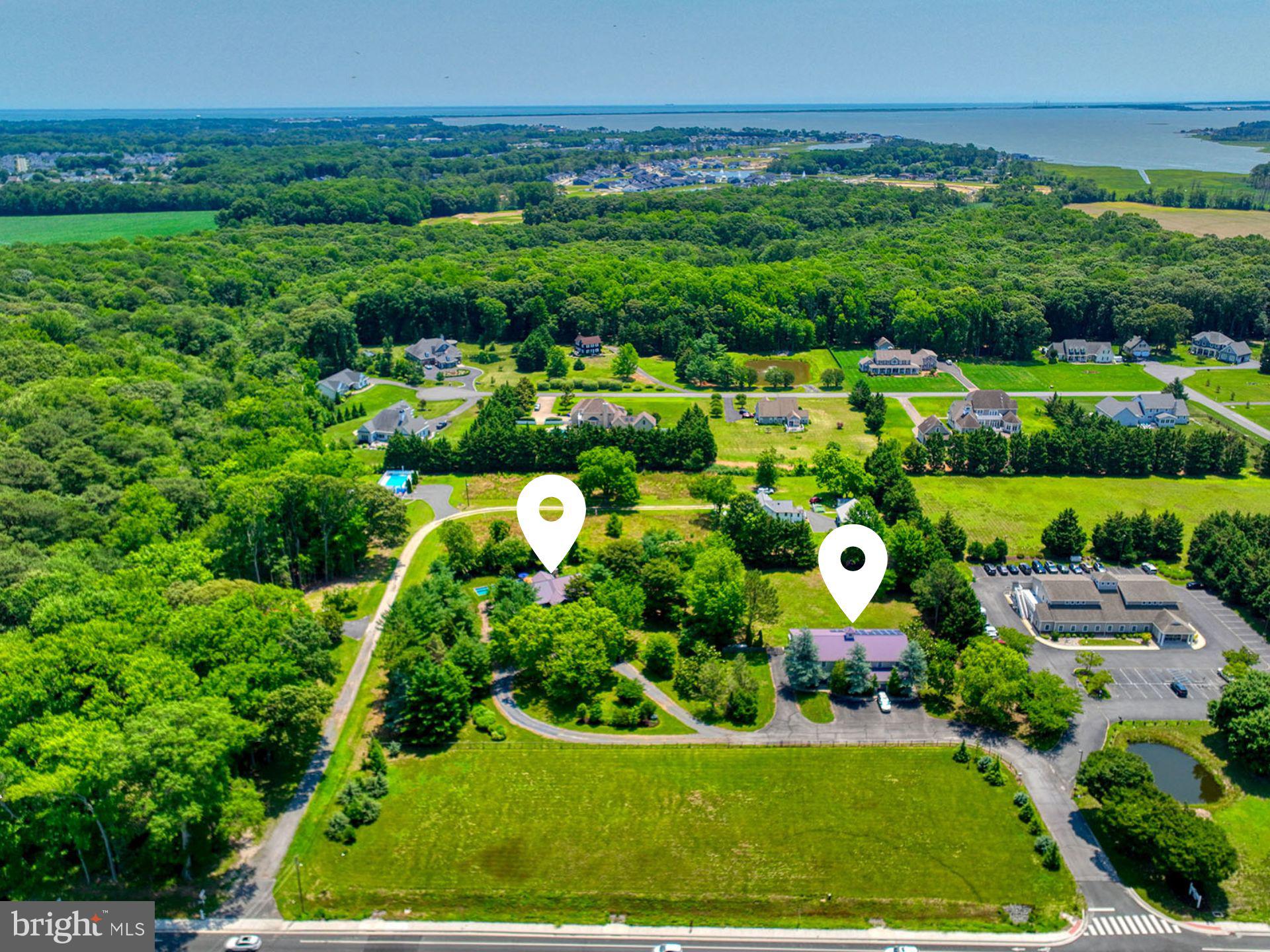 A truly rare opportunity to own approximately 3.63 acres consisting of two contiguous parcels along highly traveled Route 24 (John J. Williams Highway), one of eastern Sussex County's fastest-growing commercial corridors. Located less than five minutes from Route 1 and surrounded by significant residential and commercial growth, this unique offering combines exceptional visibility, accessibility, and long-term investment potential.

Whether you're an investor, entrepreneur, owner-user, or someone seeking a one-of-a-kind live/work property, the possibilities here are extraordinary. Buyers may wish to explore Multi-Family, Commercial, or Conditional Use opportunities (subject to approvals), making this an exceptional opportunity for medical or professional offices, wellness services, boutique retail, personal services, contractor offices, mixed-use concepts, and other business ventures seeking prominent exposure in a rapidly expanding area.

The property includes a distinctive contemporary home offering three bedrooms, an open-concept floor plan, geothermal heating and cooling, and a private backyard complete with an in-ground pool surrounded by mature landscaping. An expansive front field creates an impressive setting while offering additional flexibility for future use.

Adding to the property's appeal is the former glass-blowing studio, a truly unique structure featuring additional bedrooms and a bathroom on the upper level, creating incredible flexibility for studio space, offices, guest accommodations, creative pursuits, or future business opportunities.

Properties offering this combination of acreage, location, existing improvements, and future potential rarely become available. While the two parcels are listed separately in the MLS, they are being offered and sold together as one property. This represents one of the most unique investment and development opportunities to come to the open market in Sussex County in many years.  Also listed under Residential- DESU2116538.