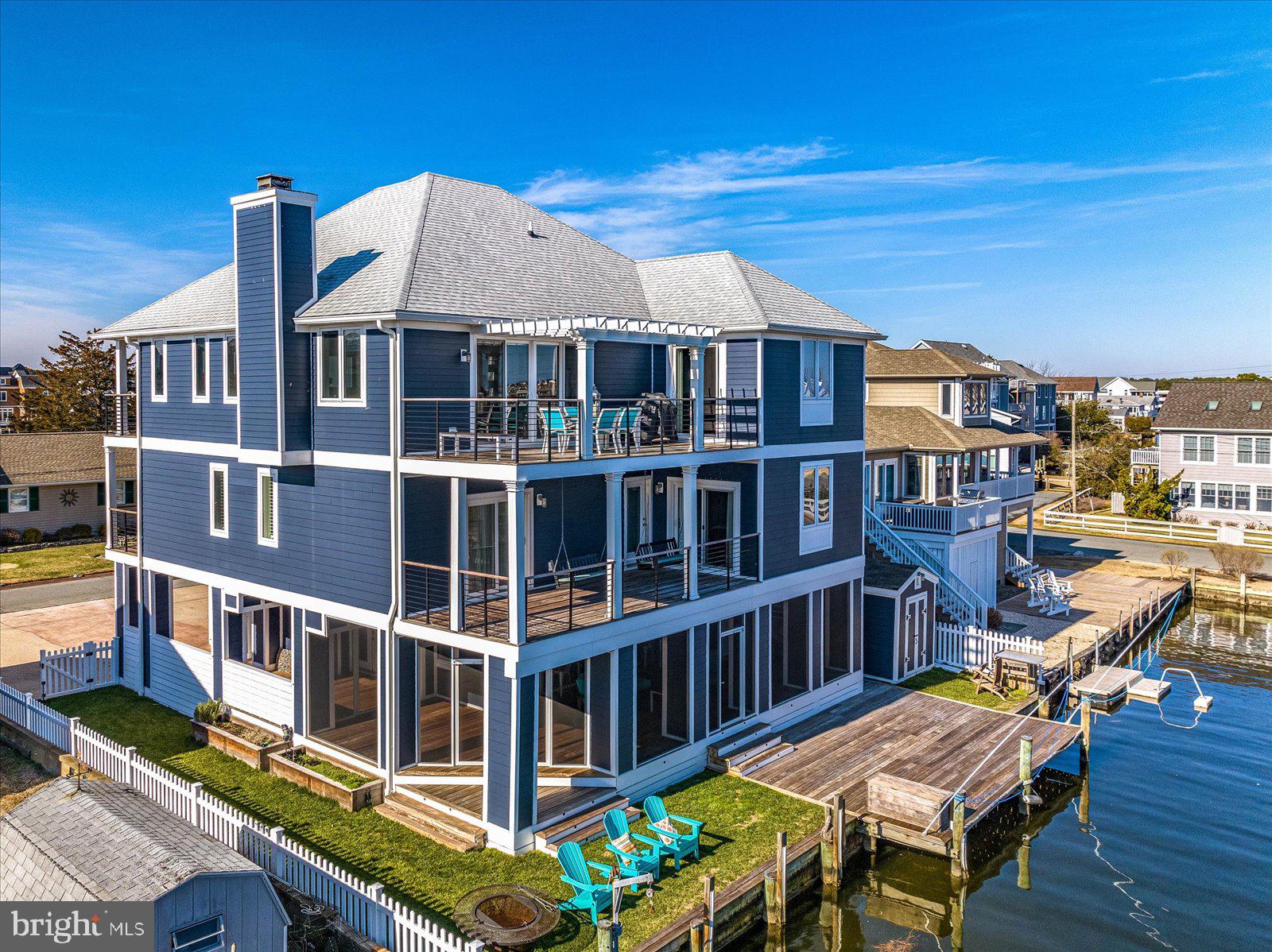Absolutely stunning waterfront home with incredible views of the bay and wetlands. Completely renovated and redesigned from the ground up. No detail has been overlooked. This spectacular home was recently featured in The Metropolitan magazine.  Located in the quiet community of Bayview Park. Situated south of Bethany, offering direct access to the beach through the state parkland dune area and effortless access to the open bay from your own private dock. Spend your days on the water and your evenings entertaining indoors and out from this thoughtfully designed three level home equipped with an elevator, five spacious bedrooms, and 4200sf of living space. The first floor features a large family room, bedroom plus full bath, and spacious bar with Bi Folding window system that opens up the space to the outdoor bar and expansive screened porch. The outdoor area is complete with an abundance of parking, green space and storage for all of your outdoor items. Enter from the front door to find a beautifully designed stairwell, high-end trim and fixtures, with unique coastal finishes throughout. The second level has four bedrooms, two with ensuite baths and each with access to the impressive Brazilian teak decks with custom iron railings that maximize water views at every turn. The private master suite and main living area encompass the top floor. The third level features a gourmet kitchen with custom cabinetry, granite and quartz countertops, gas range, Sub-Zero and Wolf appliances. The massive 8 x 8 island is equipped with a built-in microwave, two refrigerator drawers, and plenty of seating and storage. The views from this level are unmatched – magnificent sunsets from the large kitchen window, dining room slider and West facing balcony, then sunrises can be enjoyed from the Master Suite and East balcony. The master offers incredible views down the canal, a luxury bath with heated tile floors, walk-in closet, custom woodwork, and a beautiful tray ceiling. The family room features a gas fireplace, wet bar with icemaker, and is filled with natural light. There are wonderful automated shades that are light filtering but do not block the views. This one-of-a-kind, luxurious coastal residence must be seen to be appreciated. Call to schedule your private tour.