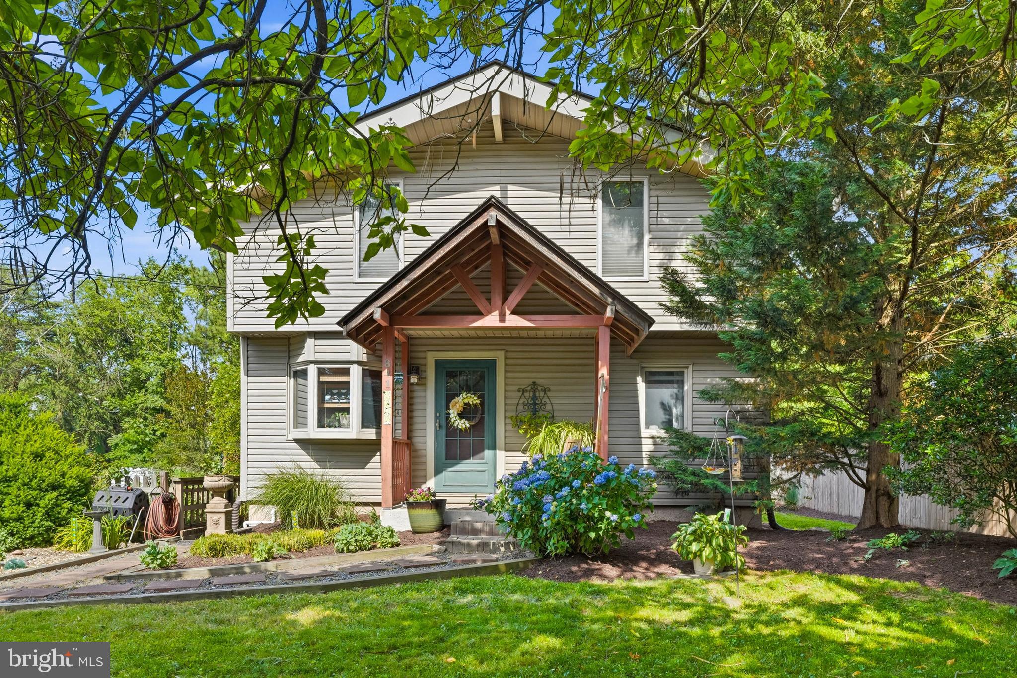 OPEN HOUSE SAT, JUN 27, 1;00-3:00! Adorable, cozy, and updated cottage-style home in a desirable location with a charming fenced front garden and private fenced back yard. Located on a quiet no-through street, this home is within walking distance to Magothy Creek with boat launch access, Mago Vista Park, tennis courts, basketball courts, playground, hiking paths, pickleball, and The Point Restaurant. A complete renovation in 2003 expanded the footprint of the original cottage and added a huge great room with a 16' cathedral ceiling, hickory floors, Anderson windows, and a center stone fireplace, an upper level with two bedrooms, a renovated kitchen, and a detached two-car garage with interior stairs to a spacious garage attic offering excellent storage or potential conversion to a studio or apartment. A covered side deck off the great room is a perfect place for outdoor dining. The full basement offers improved areas ideal for storage, hobbies, or a workshop. The home has been lovingly maintained, with major systems already replaced, including the roof in 2020, HVAC in 2017, and the hot water heater in 2017. Easy access to commuter routes and located in the Broadneck school district. A perfect place to call home!