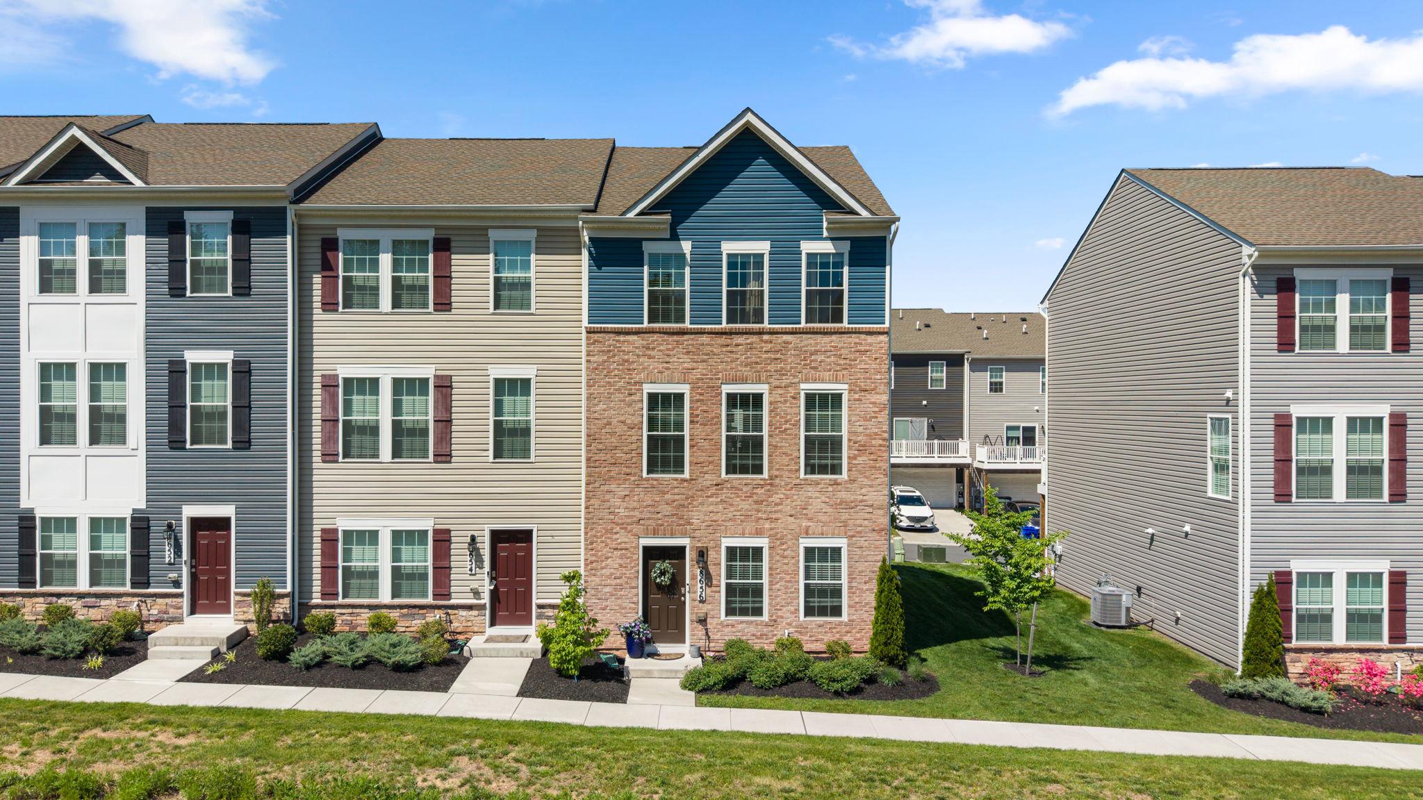 Beautiful end-unit townhome offering three finished levels, four bedrooms, and 3.5 baths with a spacious open floor plan and abundant natural light from front and side windows. The main level features stylish LVP flooring, recessed lighting, and an enormous Living Room perfect for entertaining. The stunning center island Kitchen boasts 42" white shaker cabinetry, granite countertops, stainless steel appliances, undermount sink, undercabinet lighting, and generous prep and storage space. The upper II level  features a spacious Primary Suite with ceiling fan, walk-in closet, and a beautifully appointed bath with recessed lighting, double shaker-style vanity, granite counters, and under-vanity lighting. Two additional bedrooms, both with ceiling fans, share a hall bath with granite vanity and tub/shower combination. Convenient bedroom-level laundry with washer, dryer, and extra shelving adds everyday convenience. The entry level offers a private 4th bedroom and full bath, ideal for guests, home office, or multi-generational living. Completing this exceptional home is a rear-entry attached two-car garage.