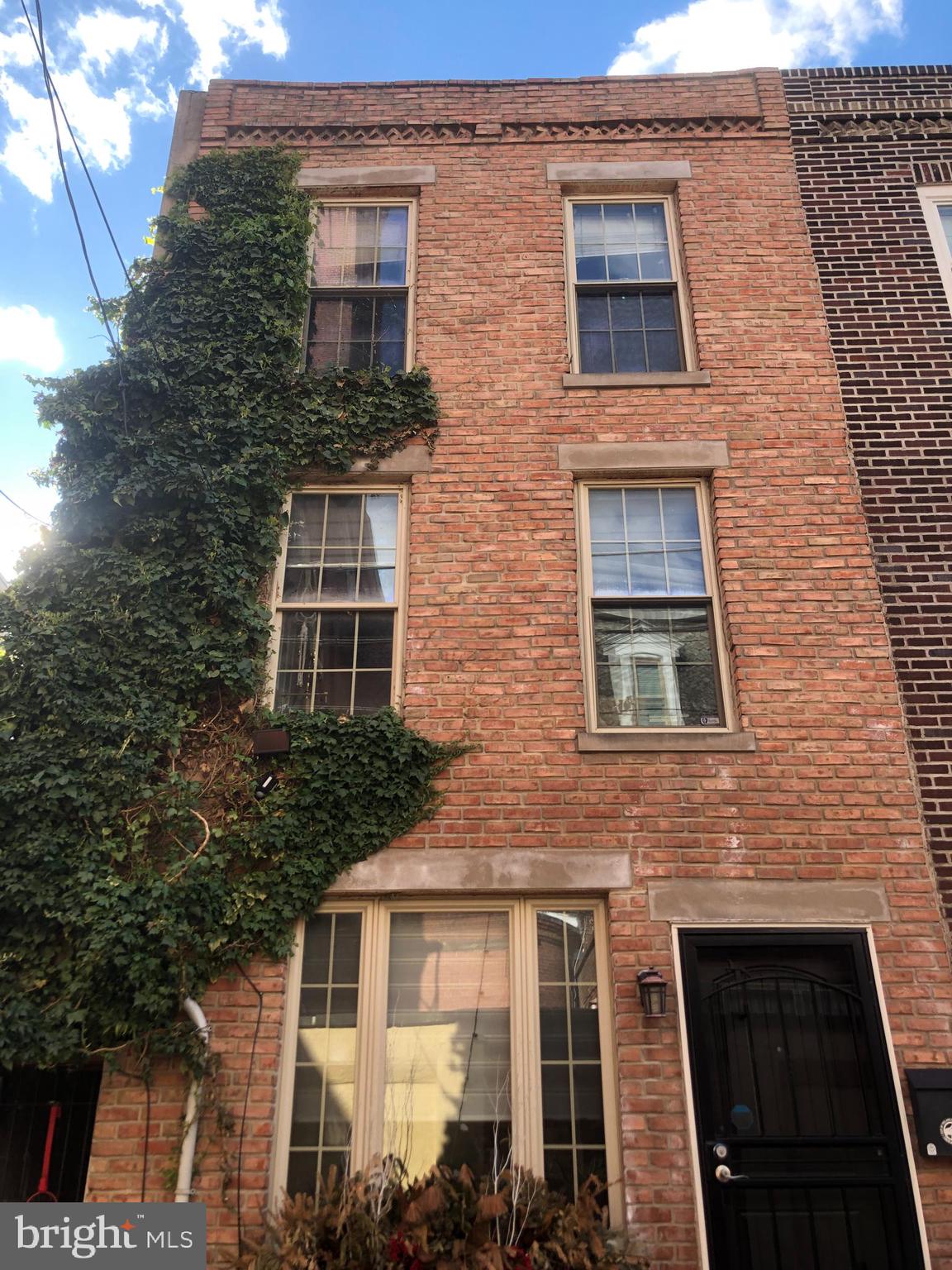 Nestled in a quiet and quaint alleyway in the heart of the desirable Bella Vista area, you’ll fall in love with this beautiful three-story townhouse. Mixed with both historic architectural charm and modern upgrades and aesthetics. The first floor features an open kitchen, living room, and back door exit to a private alleyway. On the second floor, you’ll find the first two bedrooms, where one is currently converted into your dream walk-in closet, which can also be used as a home office or nursery. The entire third floor welcomes you to the gorgeous open-concept master bed and bath. As you journey through each unique room, notice the details of every glistening chandelier and the original exposed brick walls. 
This home is one block from the Italian Market filled with historic restaurants, an outdoor fruit and vegetable market, small businesses, and coffee shops. Whole Foods and Acme are a short walk away. There is also a recreation center and playground one block away. Here you will feel a true neighborhood vibe while also getting to experience all the city has to offer. For those who love character, beauty, and comfort, come make this place your home and schedule your showing today. You don’t want to miss this unique home in this prime location.